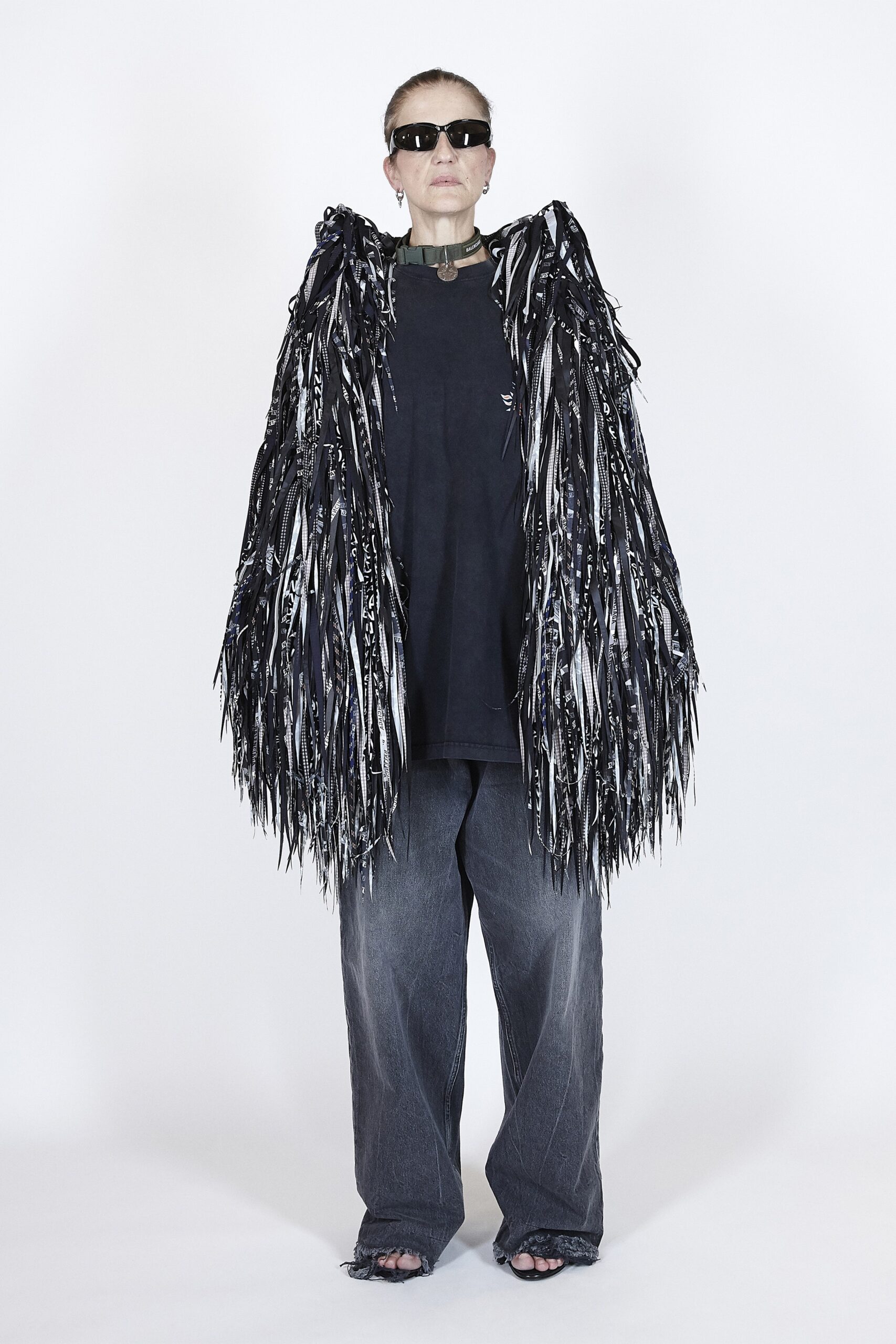 black relaxed top with fringed cape