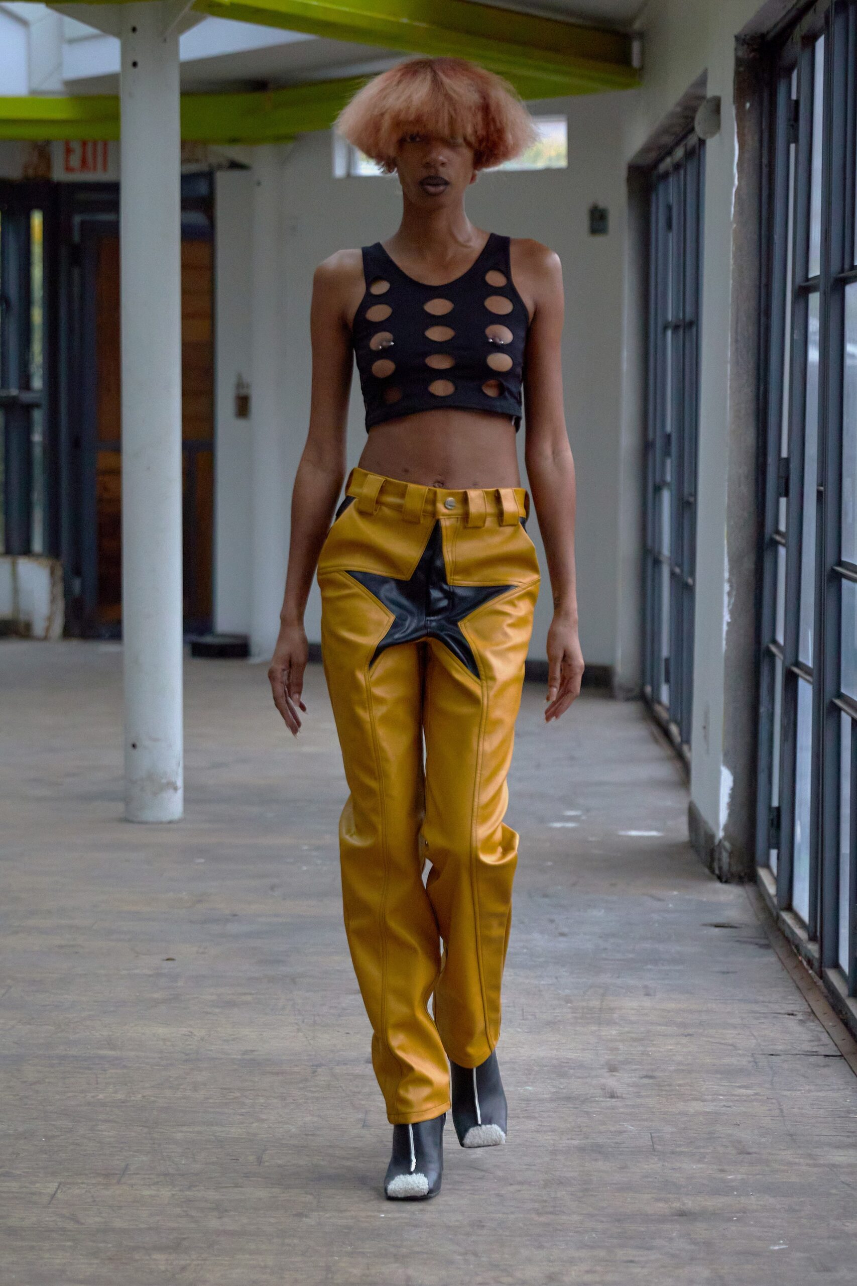 black cutout top and yellow leather pants