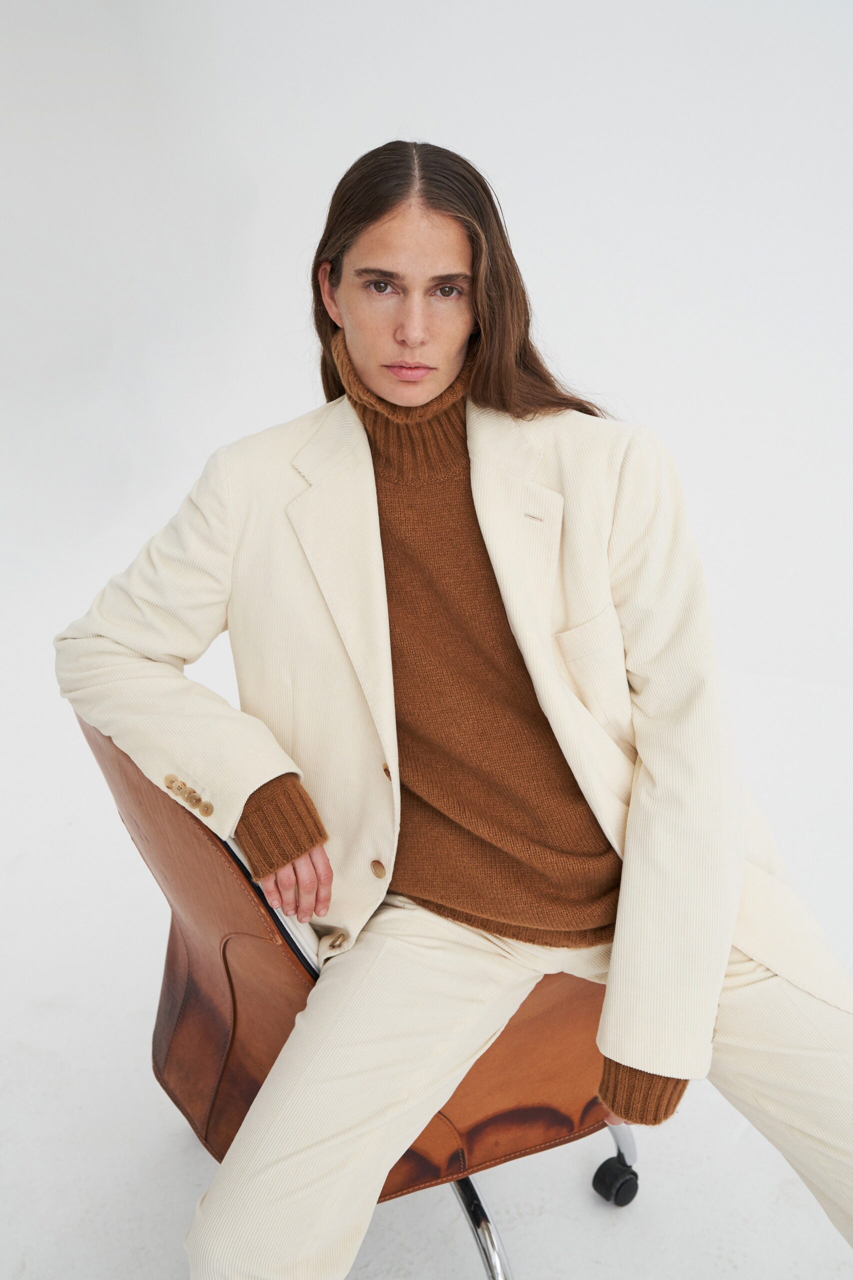 white tailored blazer with brown sweater