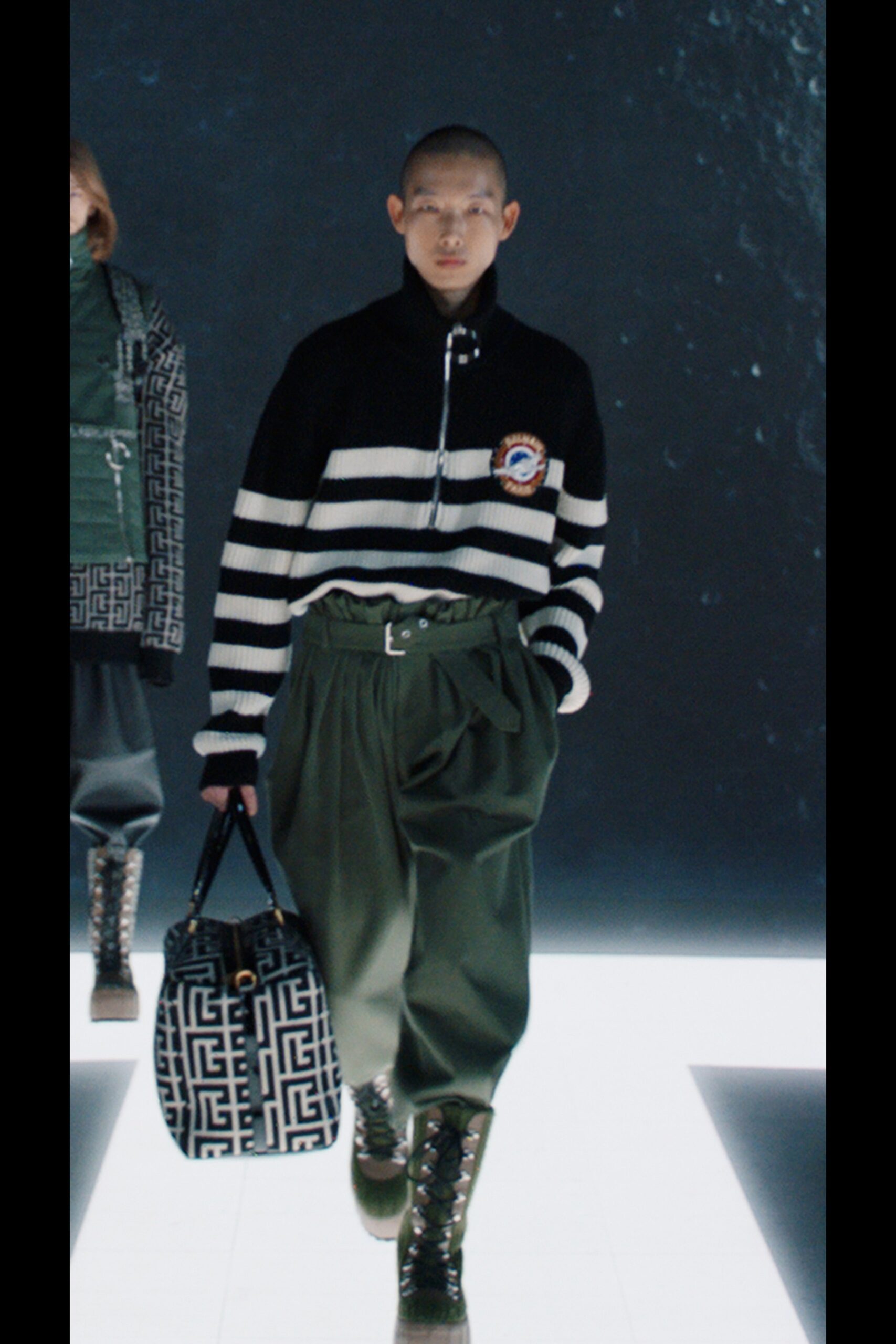 black and white striped sweater with green pants