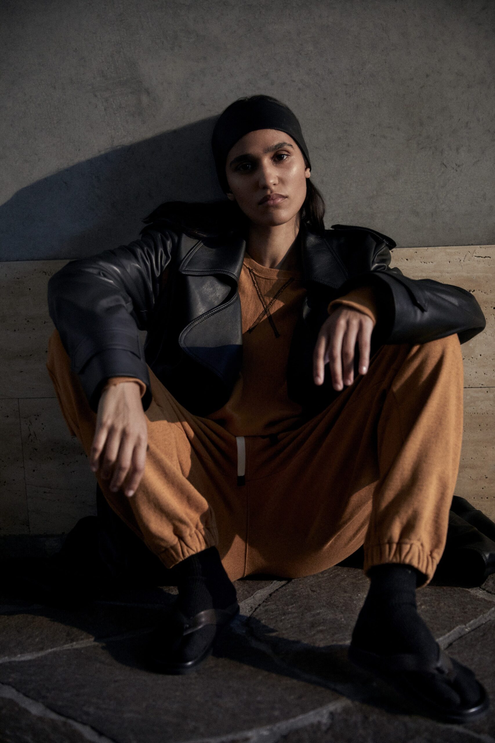 black leather oversized jacket and orange jumpsuit