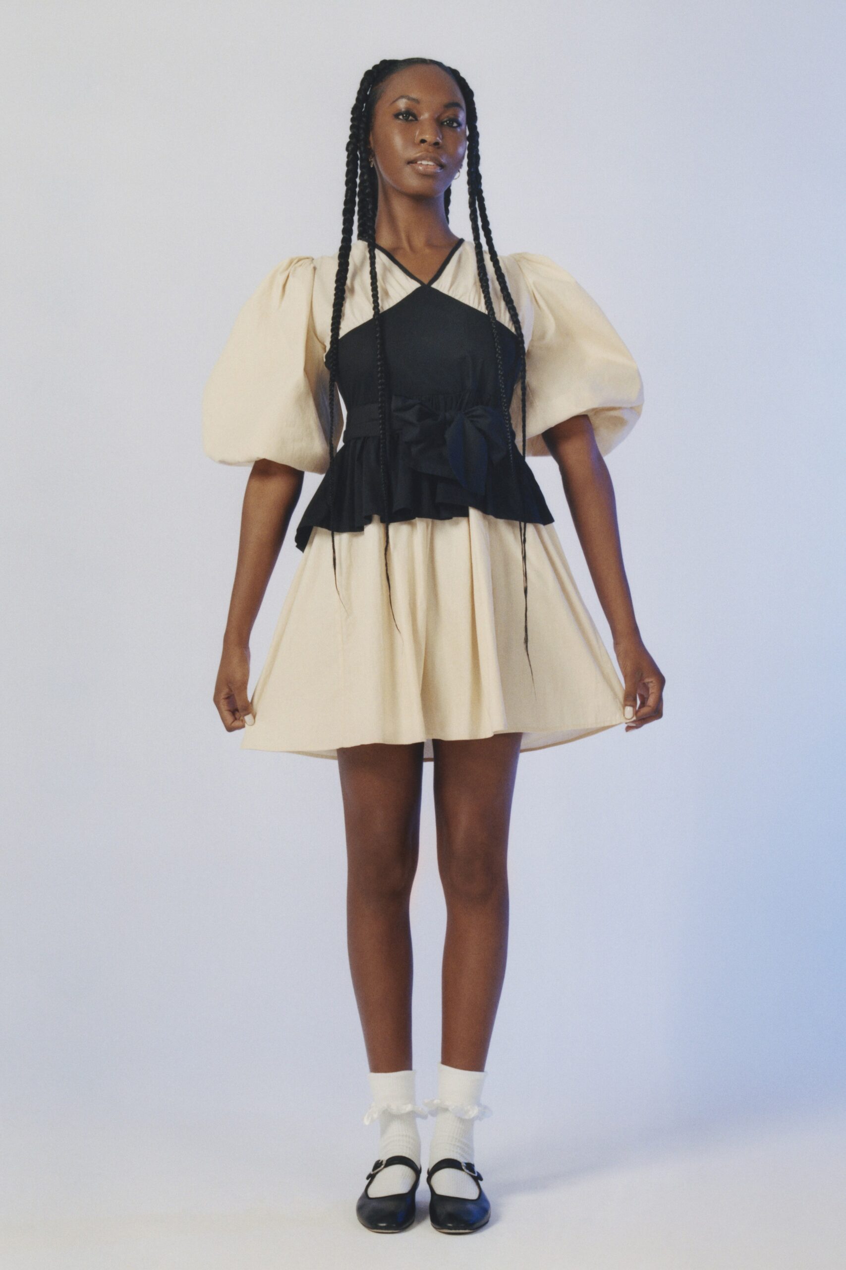 black and beige pleated dress