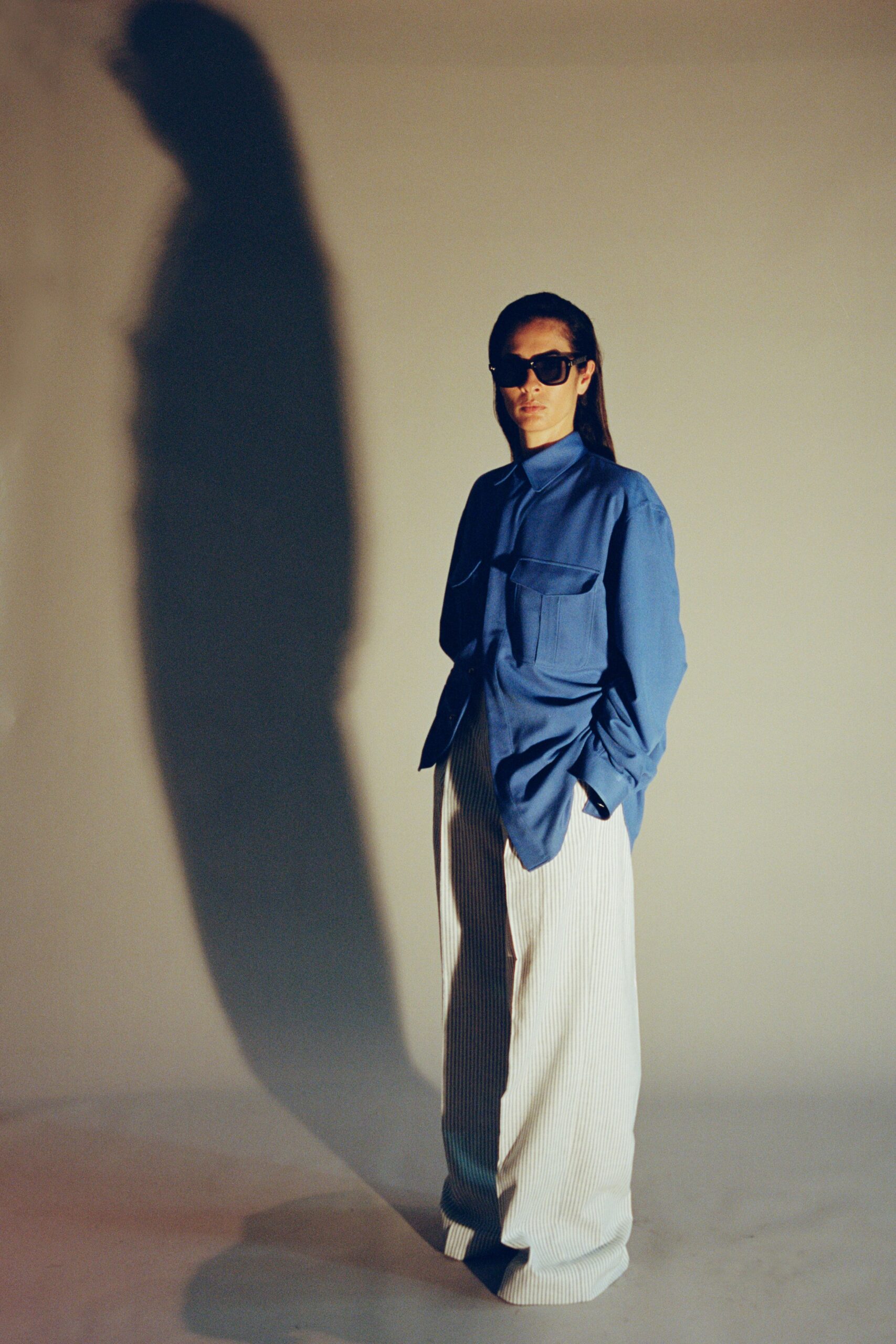 blue relaxed shirt with white striped pants