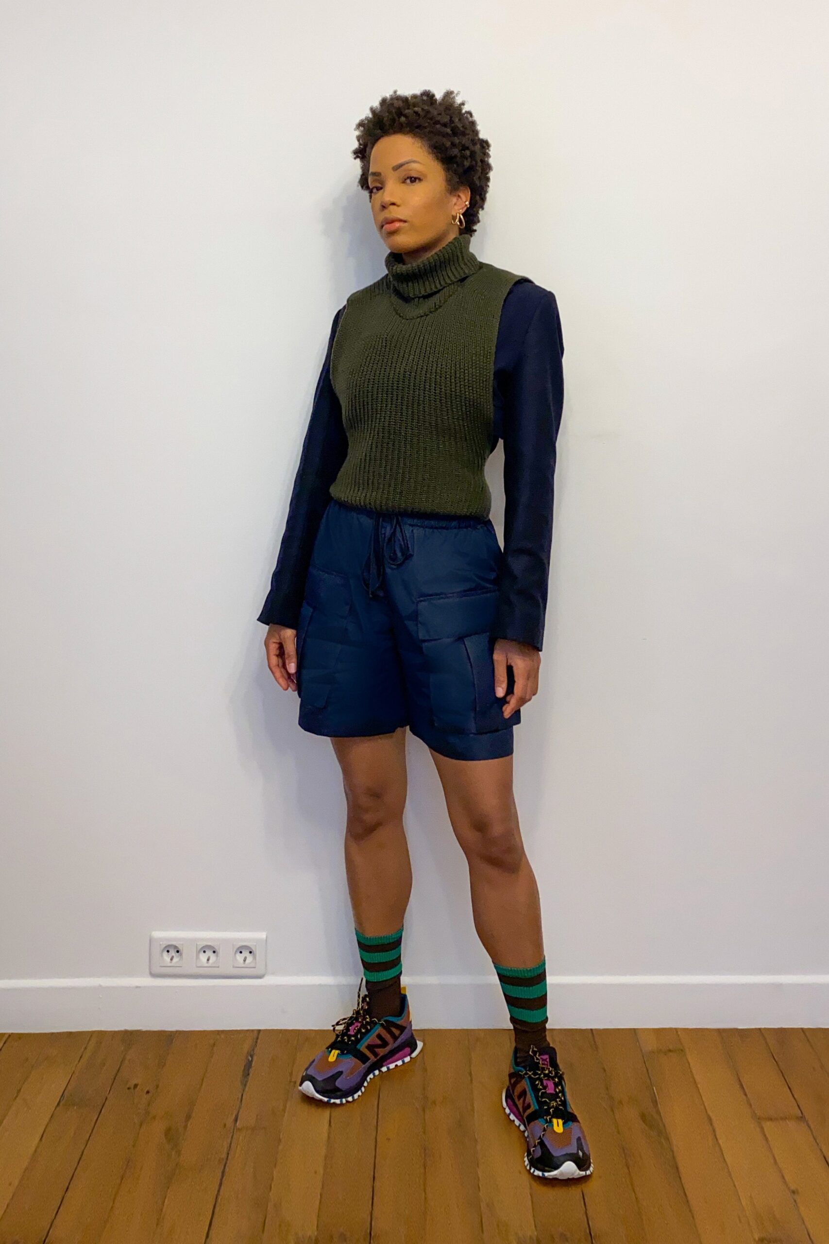 fitted green turtleneck top and blue shorts