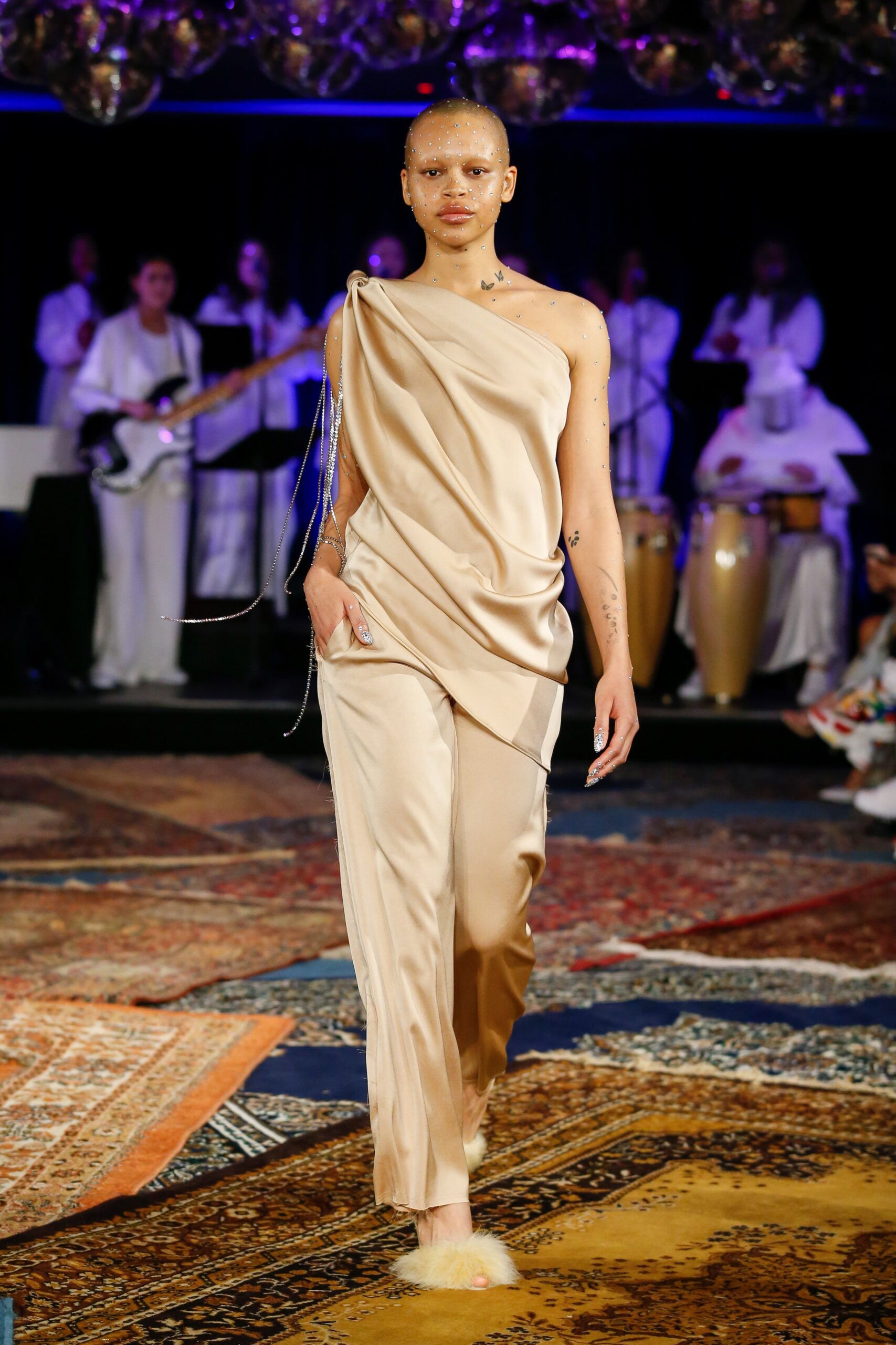 beige silk asymmetric top and relaxed pants