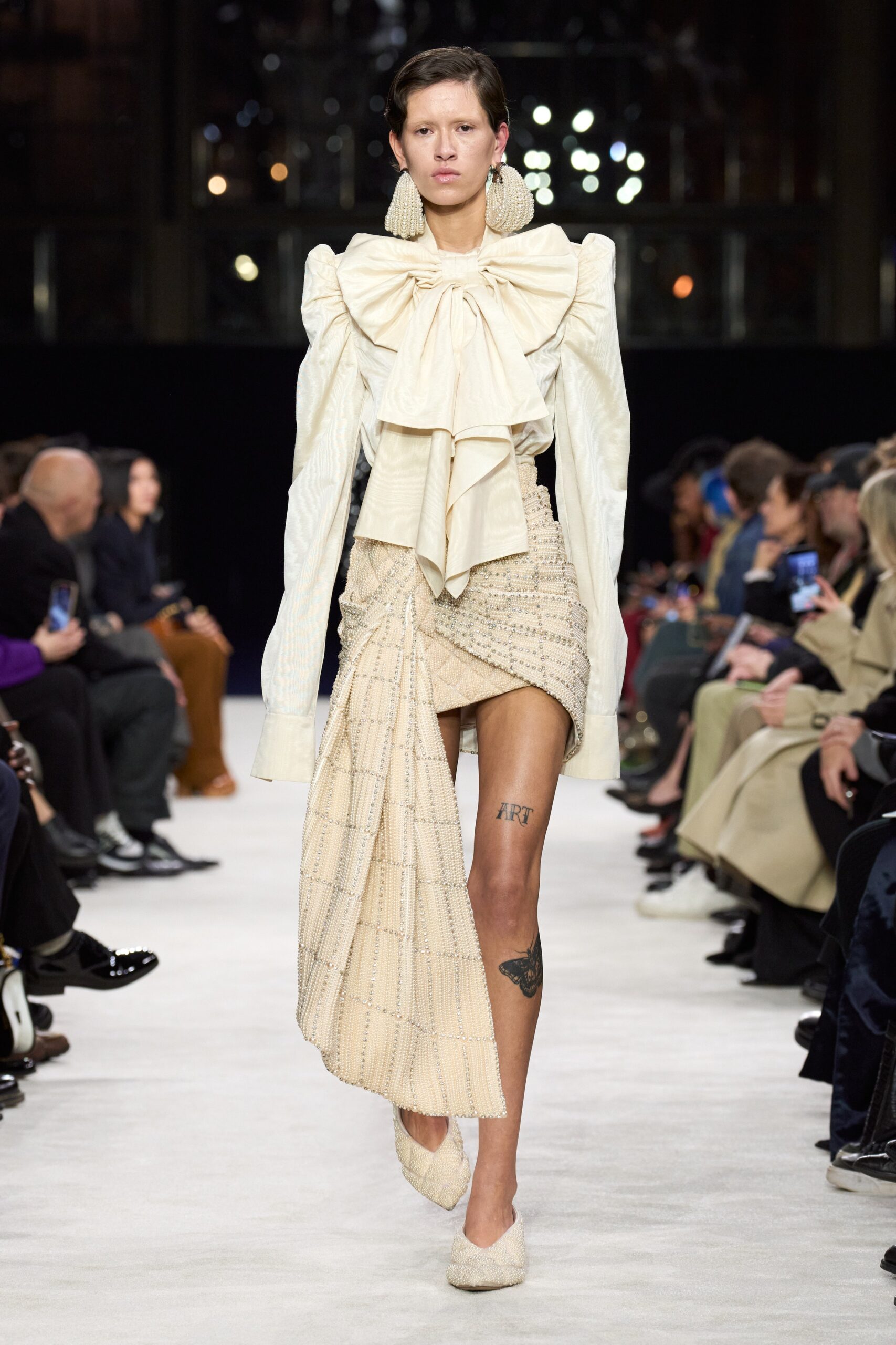 white ruffled blouse with beige skirt