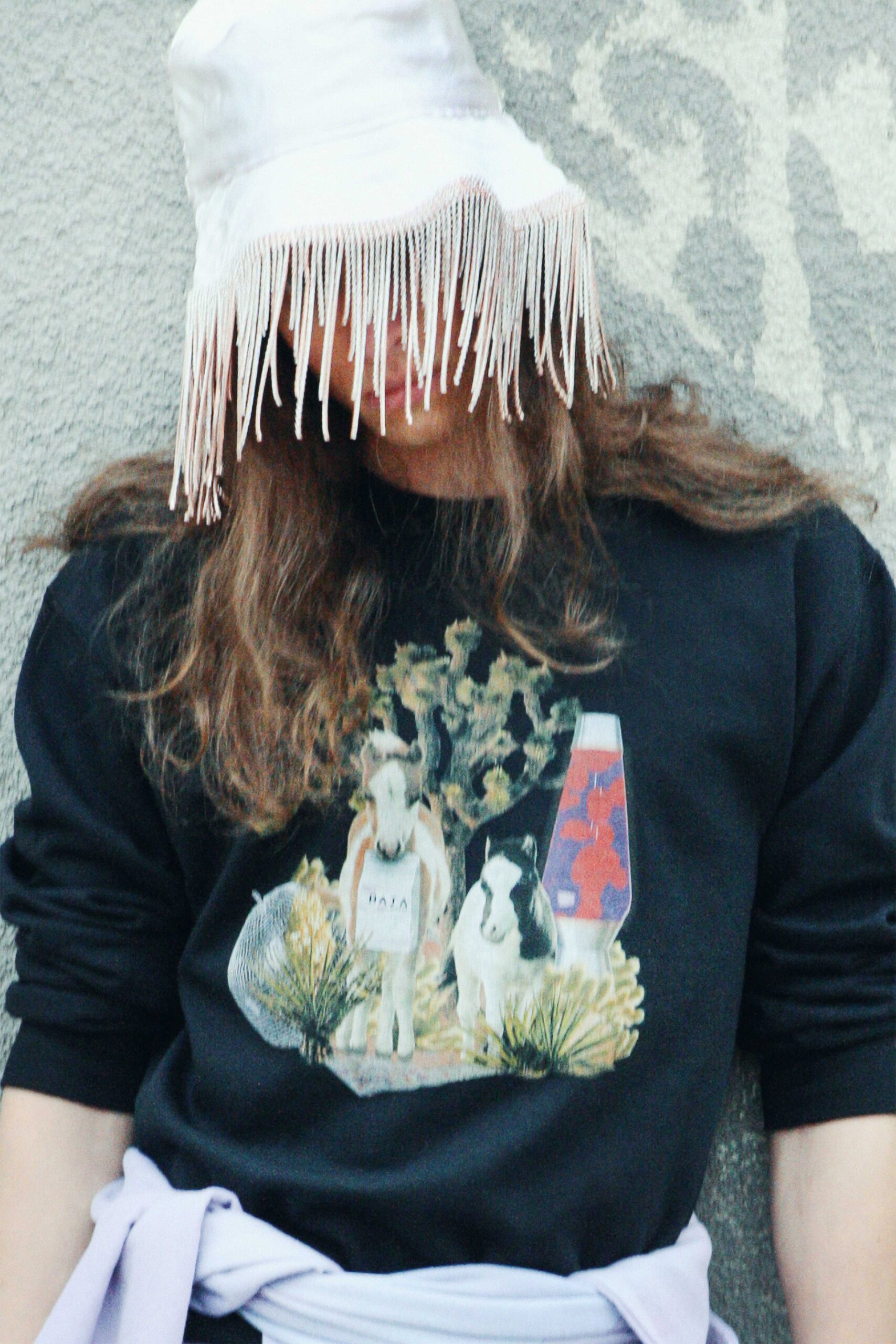 black printed sweater with white fringed hat