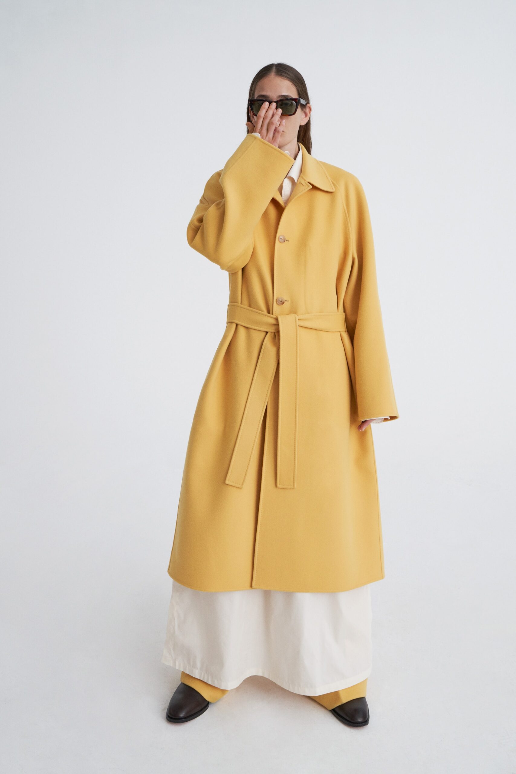 yellow oversized coat and white pants