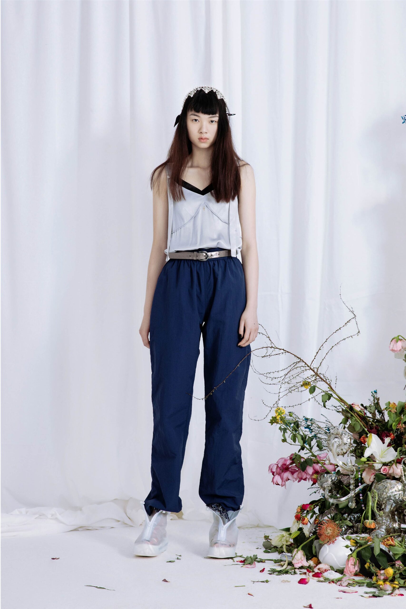 gray sleeveless top and blue pants