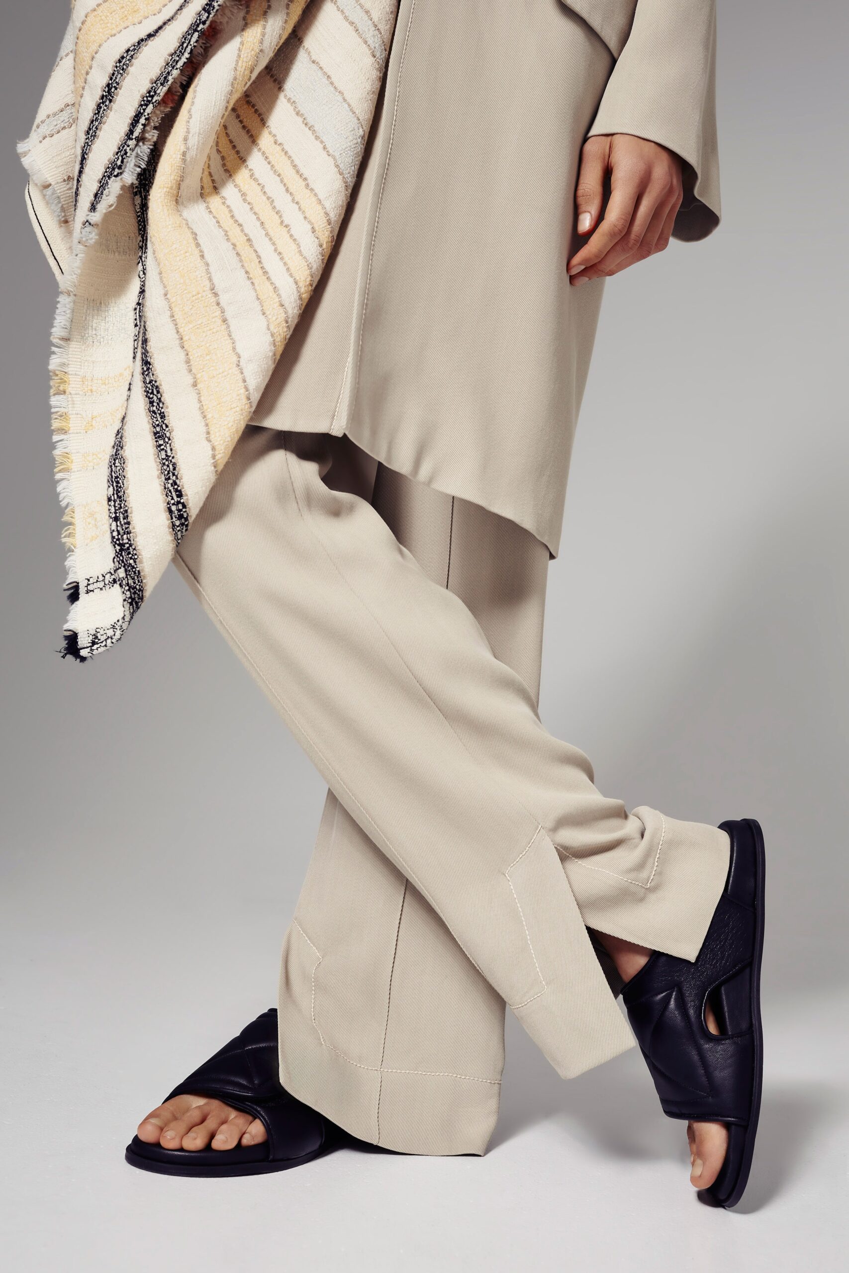 beige relaxed pants with black shoes