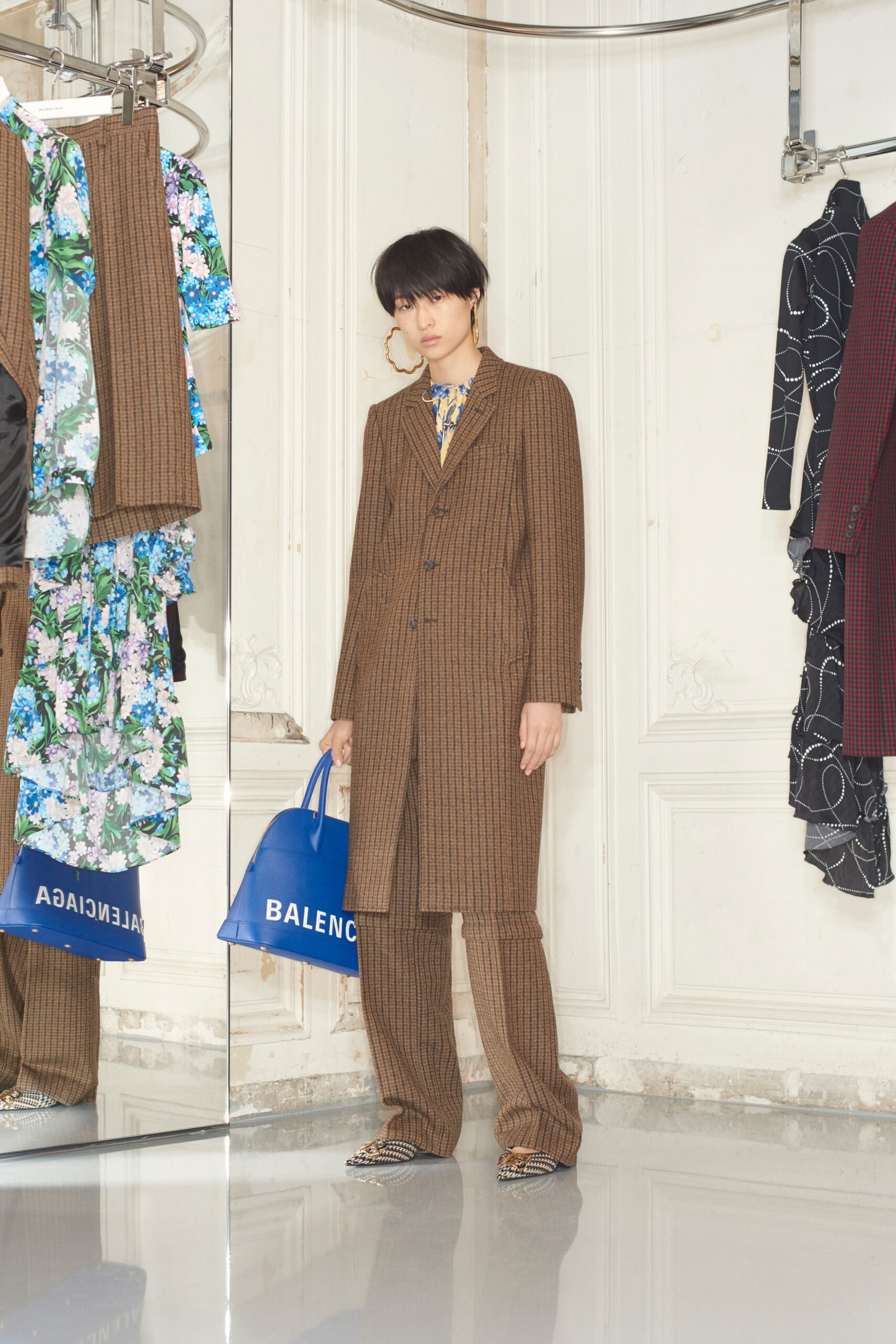 brown tailored suit with blue bag