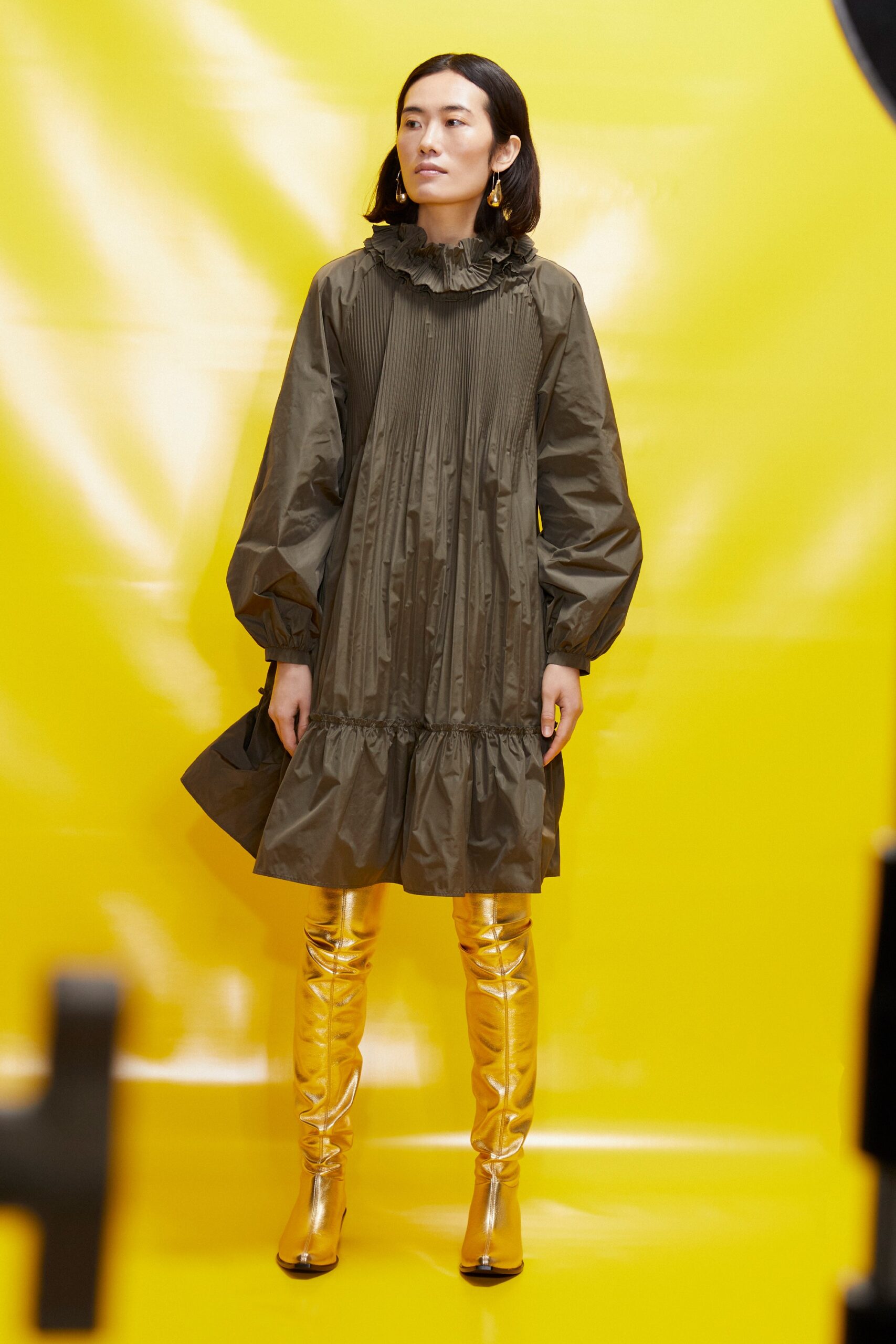 green pleated mini dress with gold boots