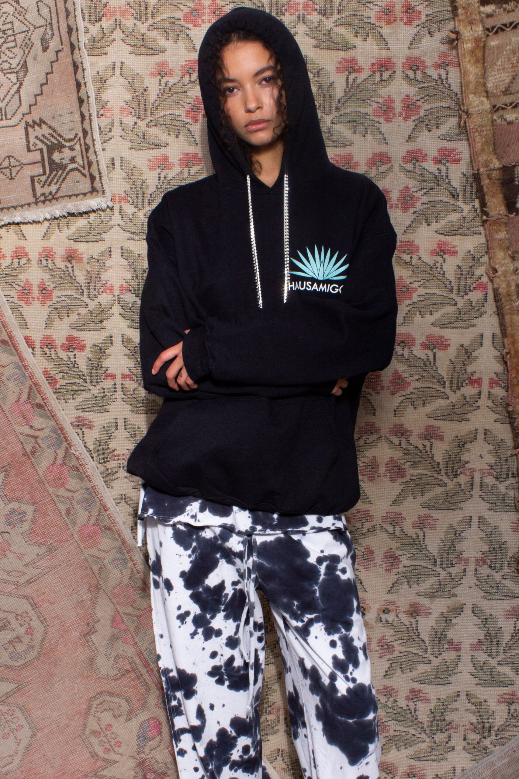 black hoodie and tie-dye pants