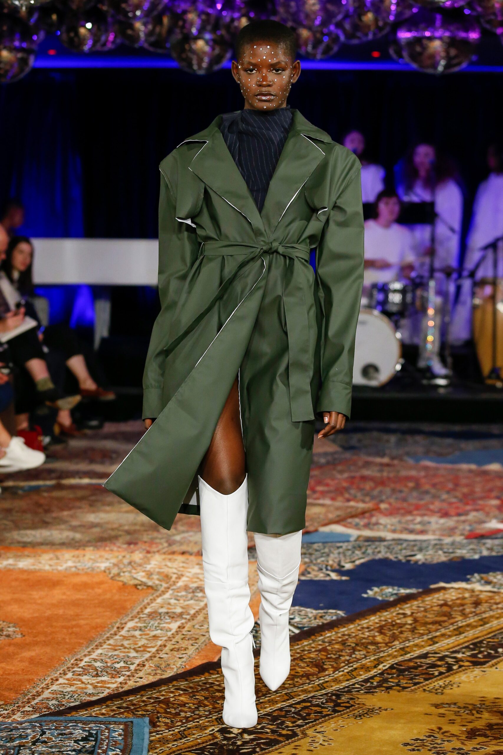 green belted coat with white boots