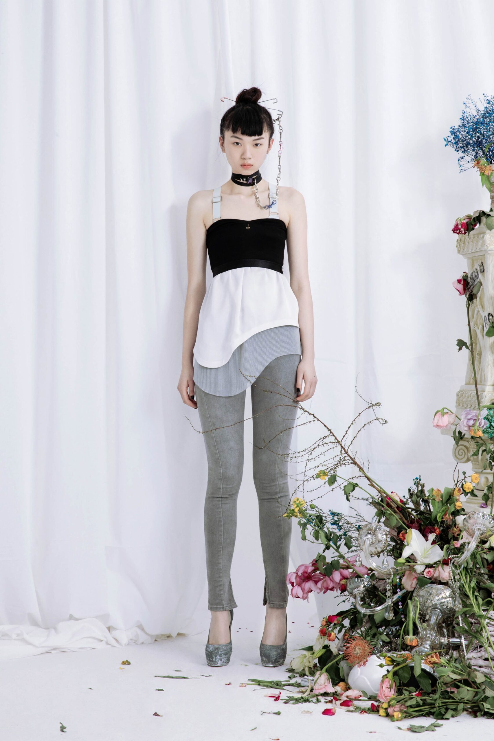 black and white asymmetric top with gray pants
