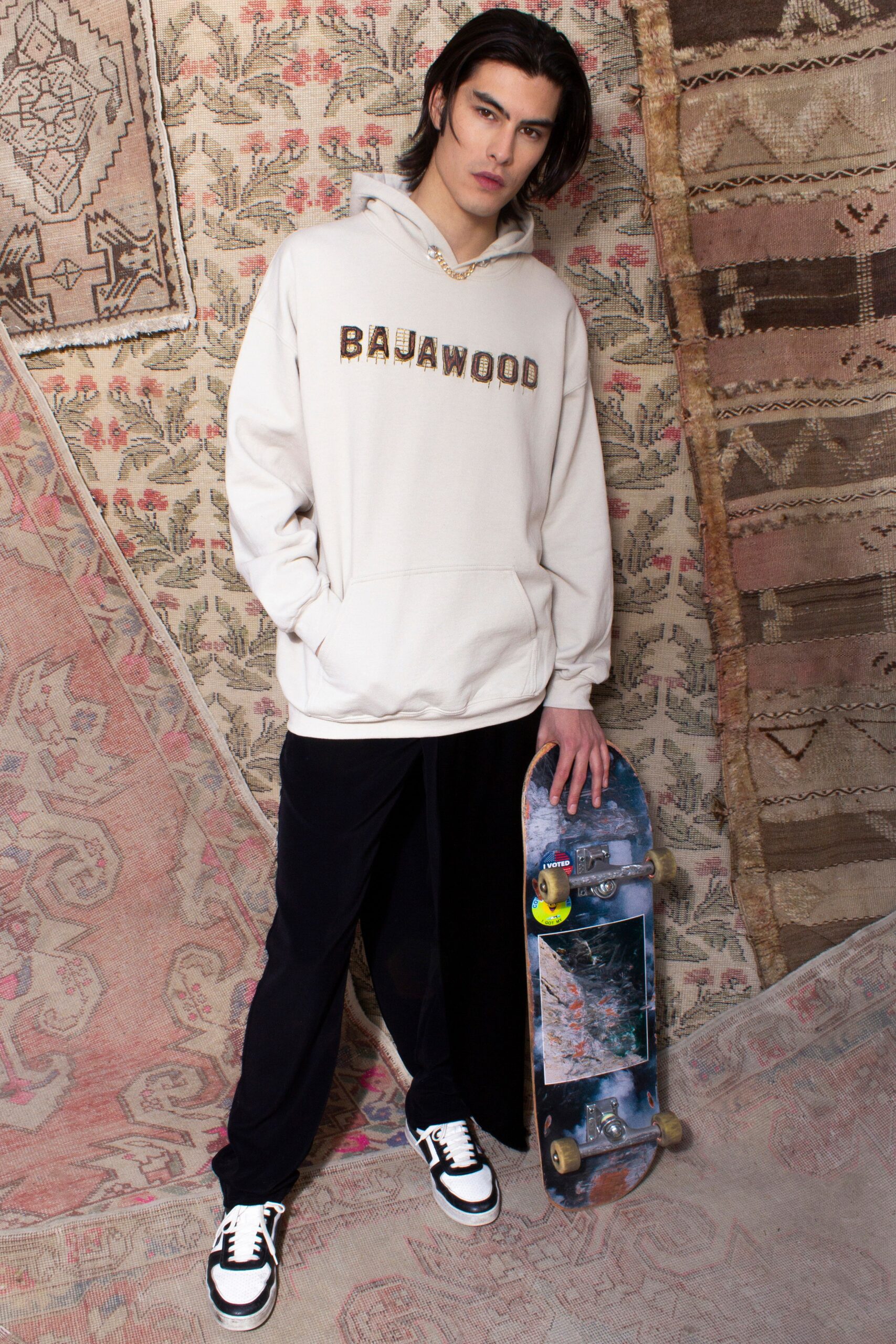 beige hoodie and black pants