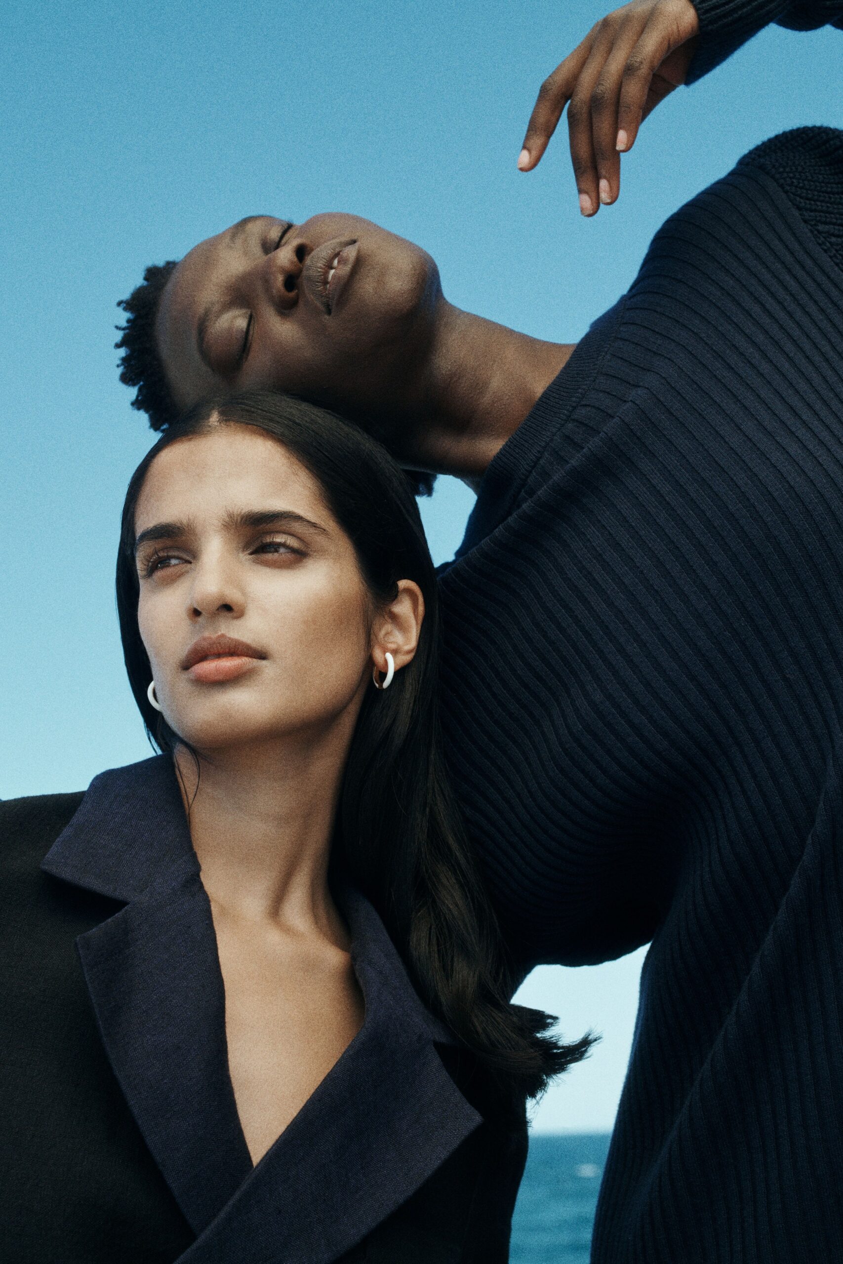 black coat and navy sweater