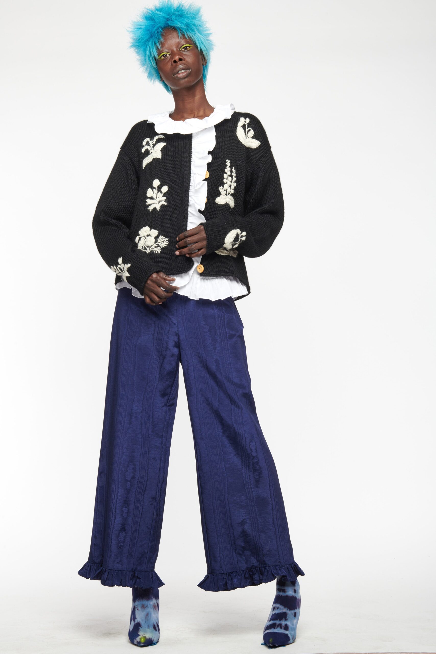 black cardigan white blouse blue pants