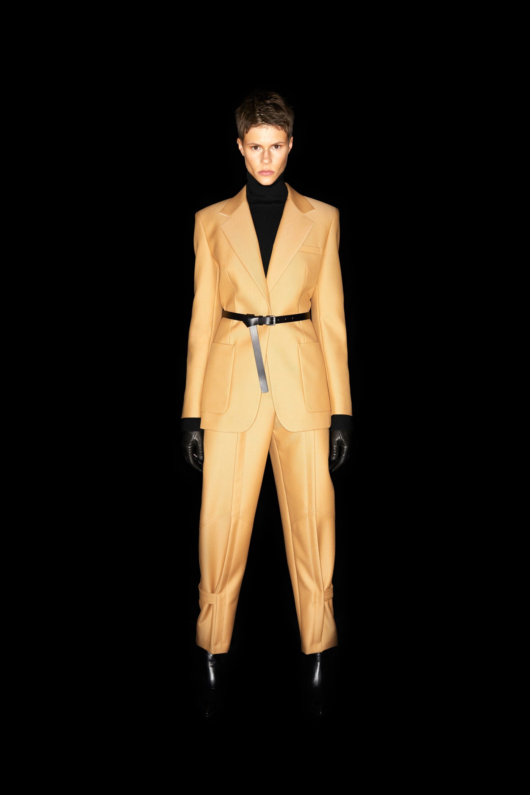 beige tailored suit with gloves