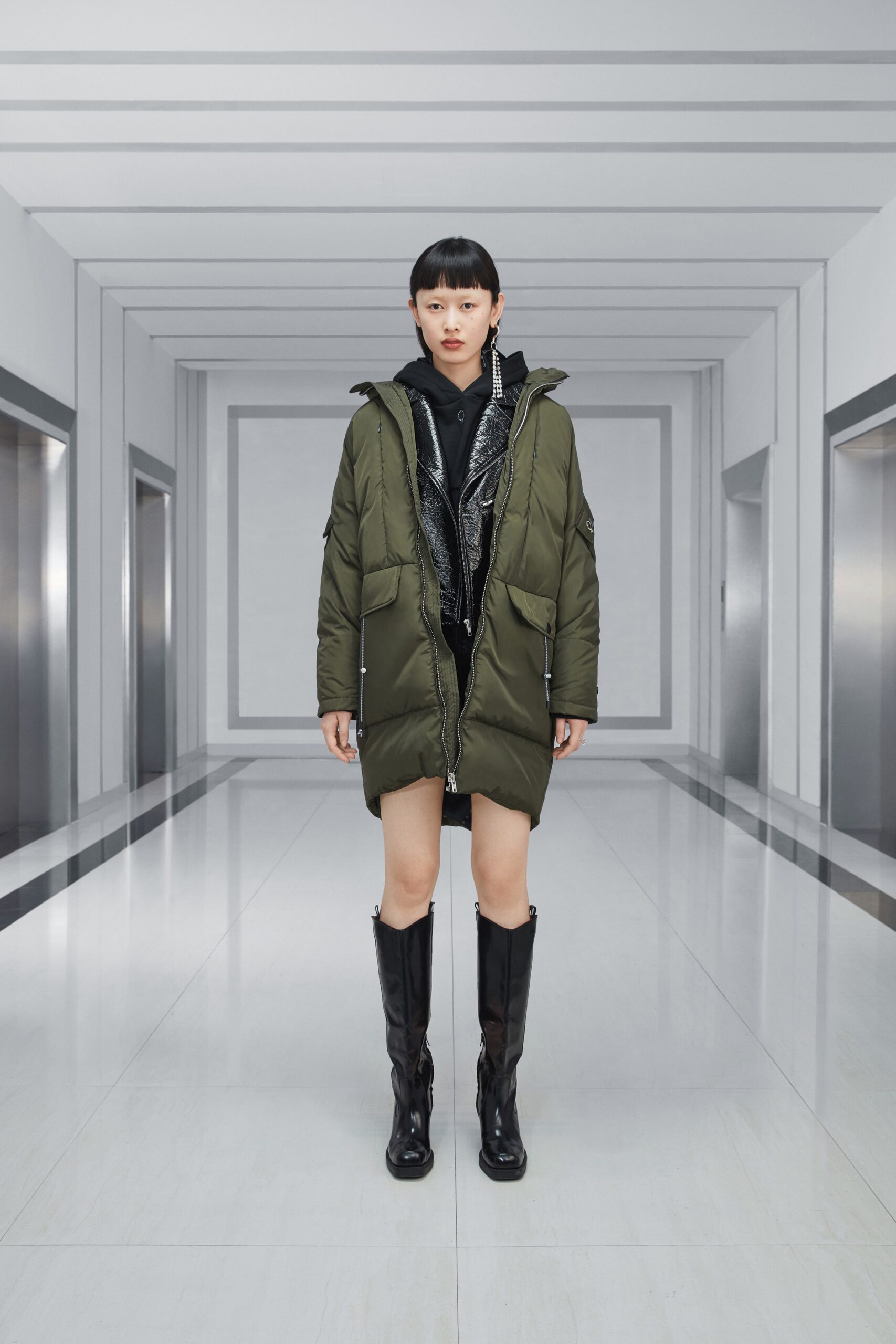 green parka with black hoodie and boots