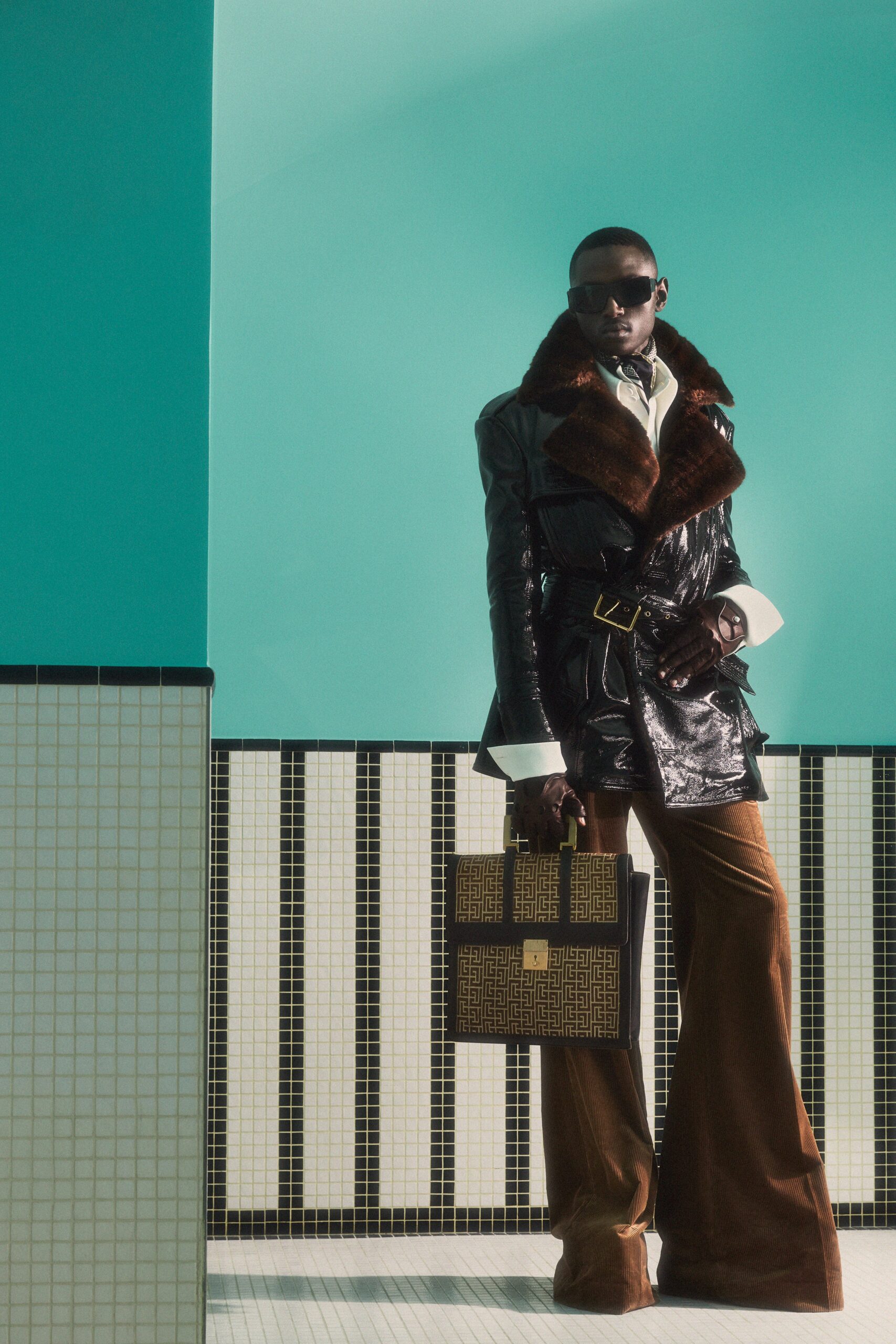 black leather coat with fur collar and brown velvet pants