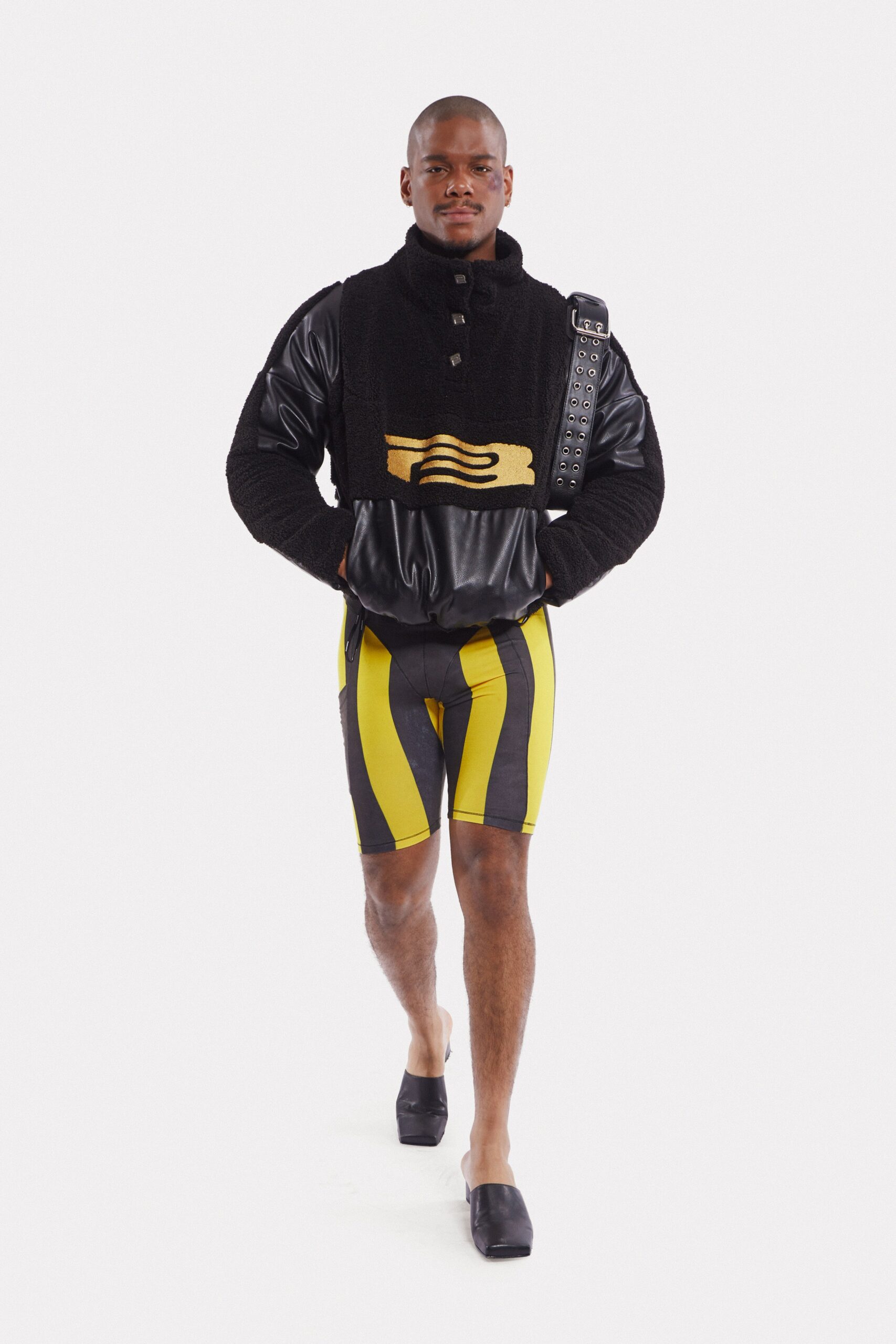 black faux-fur jacket with yellow shorts