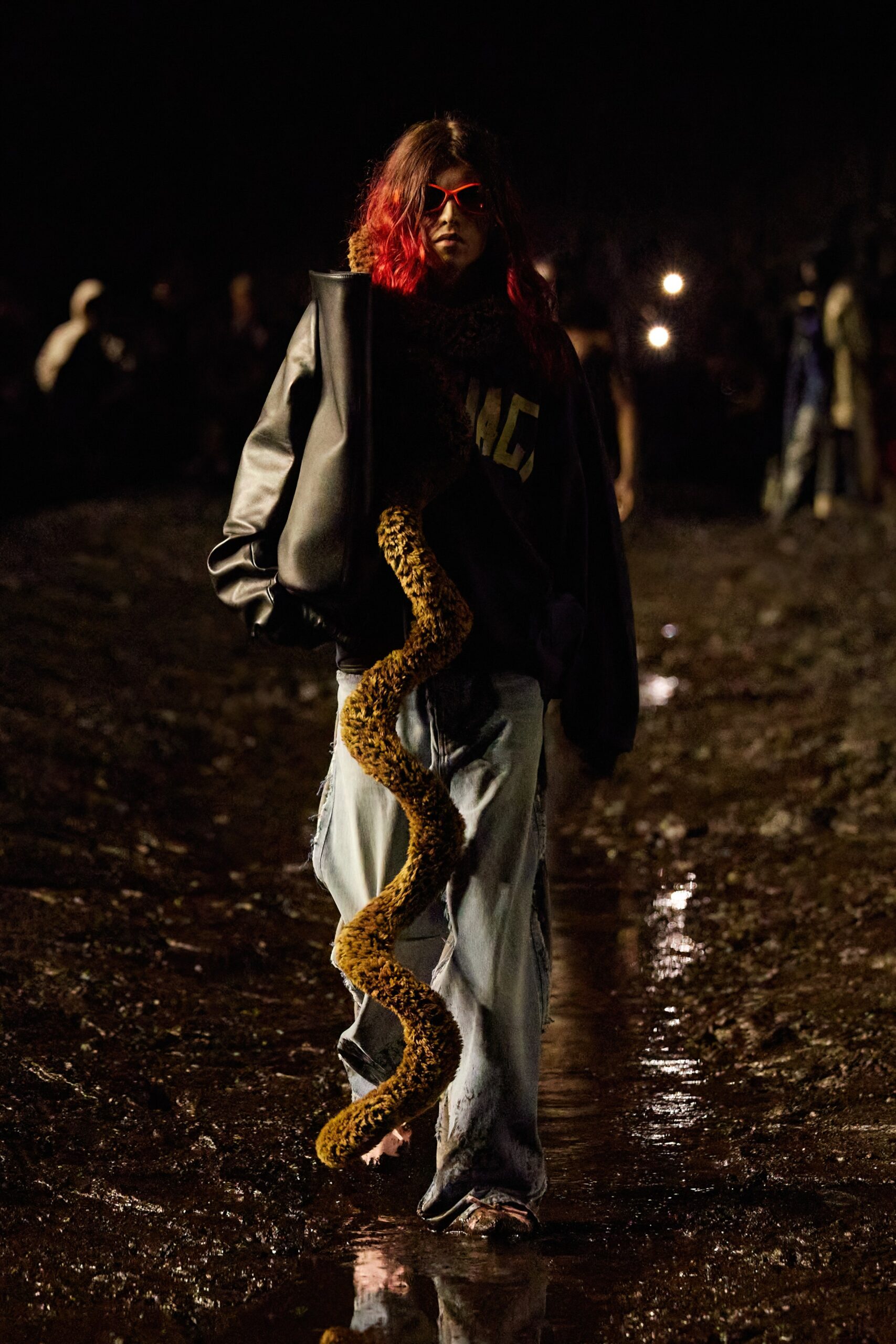 black leather oversized jacket and blue denim pants
