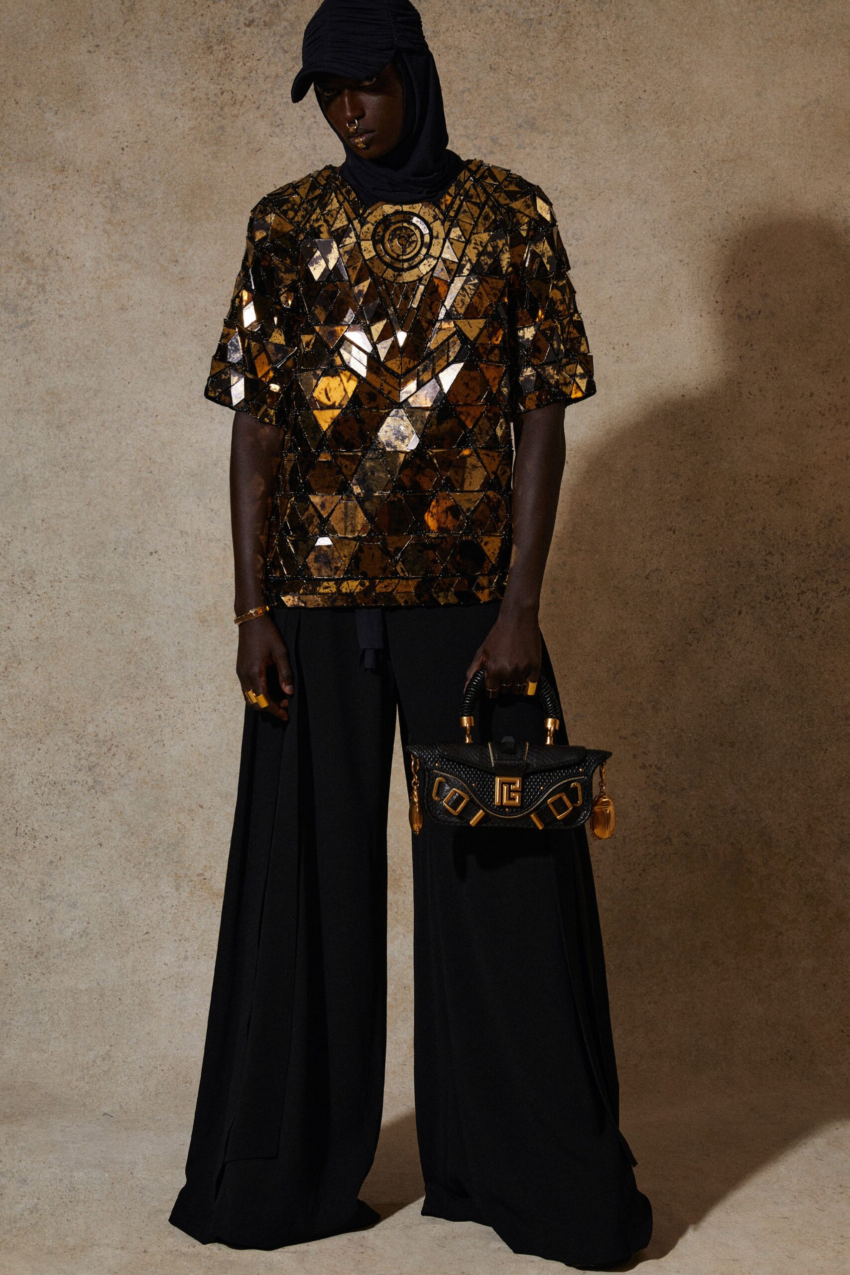 gold embellished top with black pants