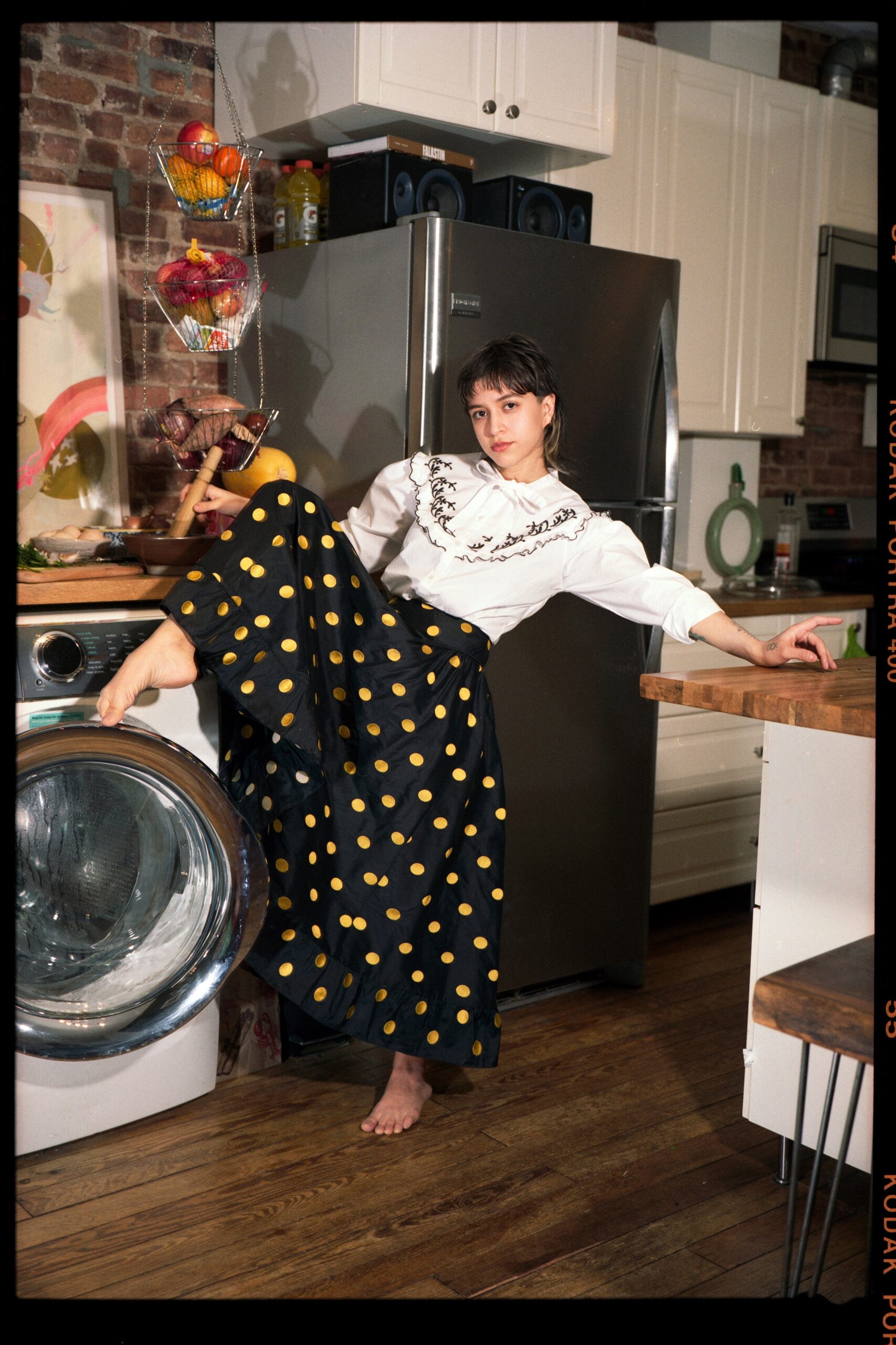 white embroidered top with polka-dot skirt