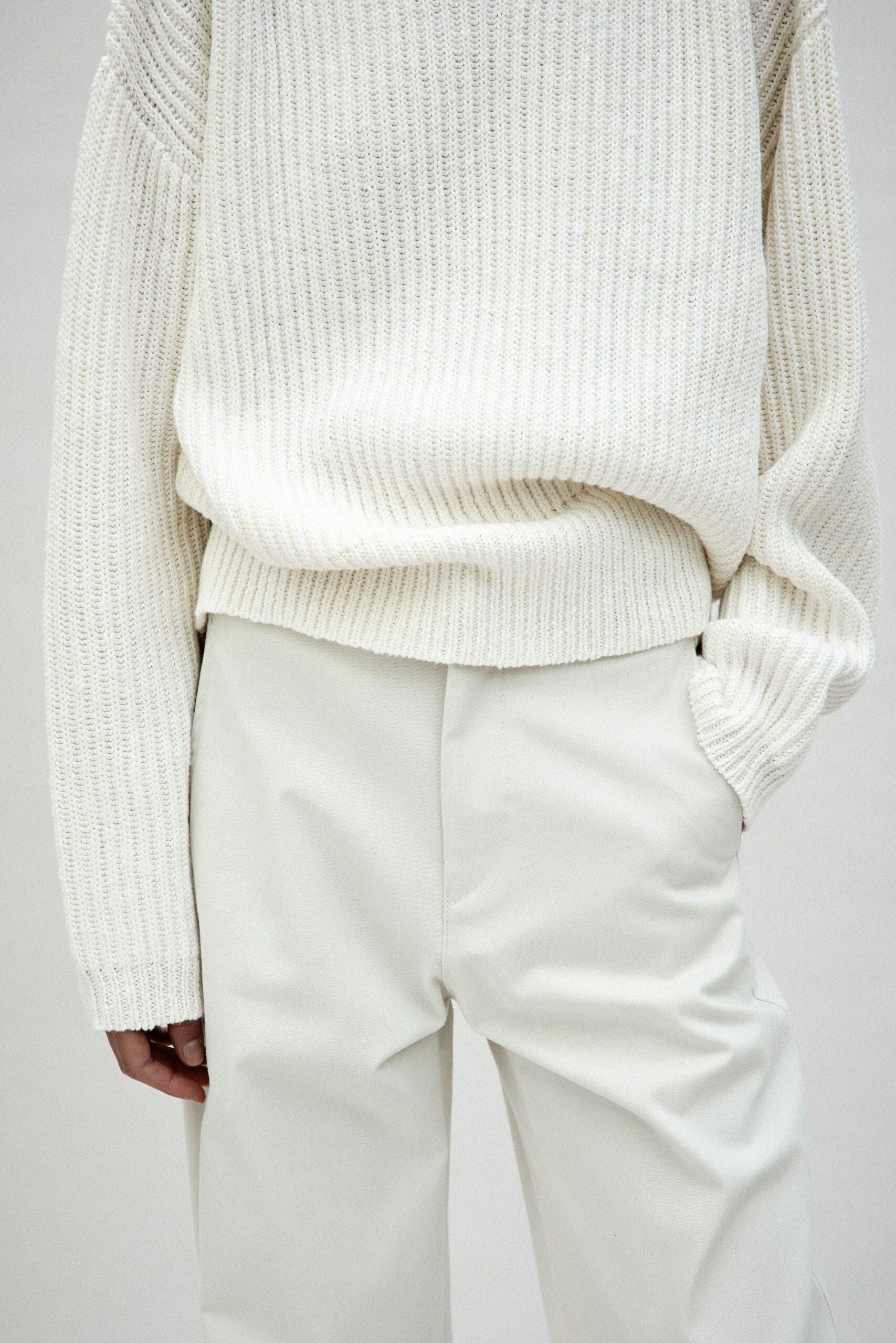 white relaxed sweater and beige tailored pants