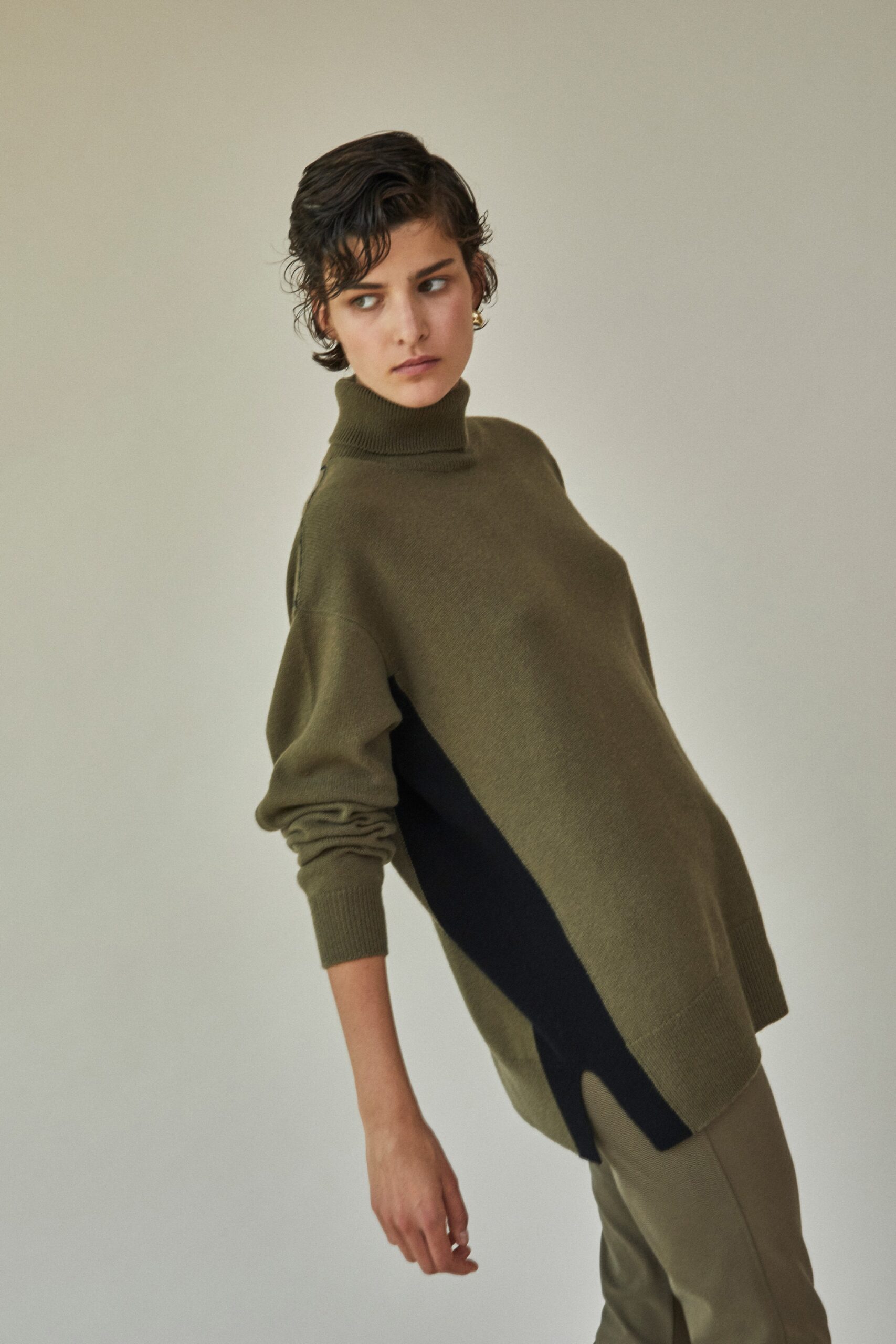 olive color-blocked sweater with tailored pants