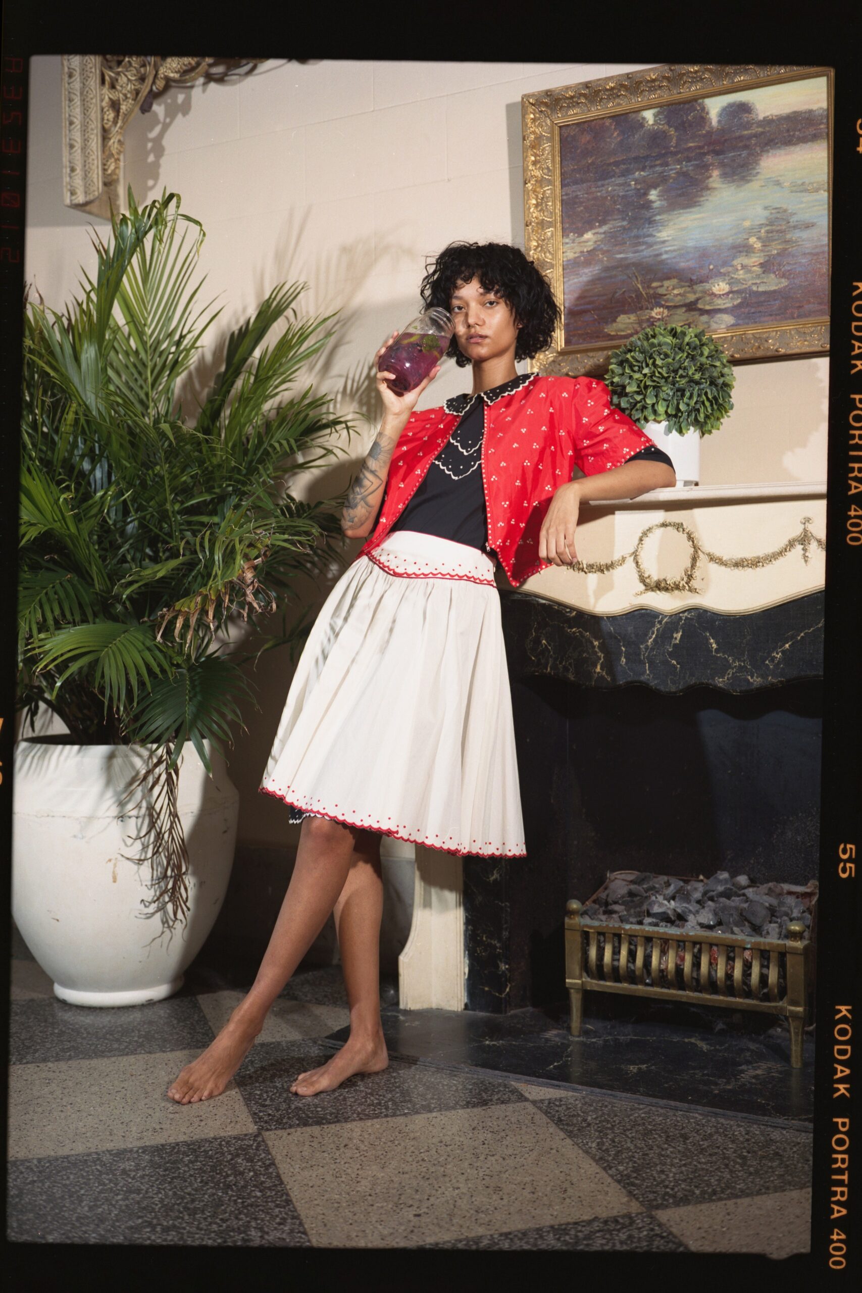 black blouse white pleated skirt red jacket