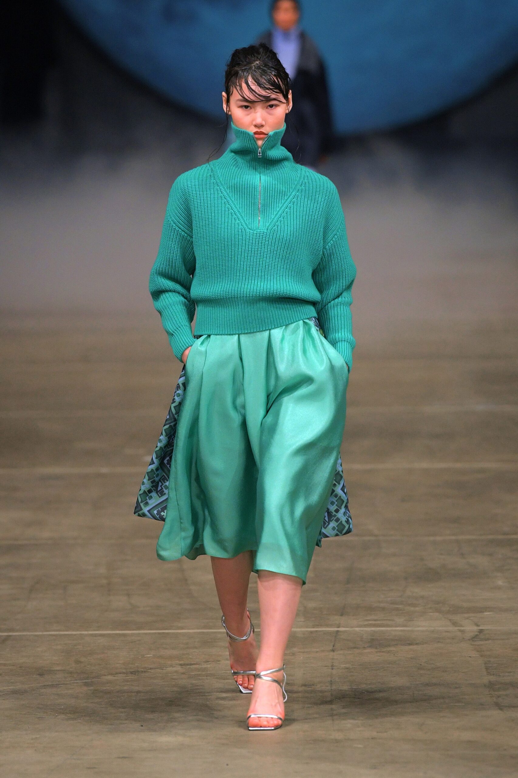 green fitted sweater and teal skirt