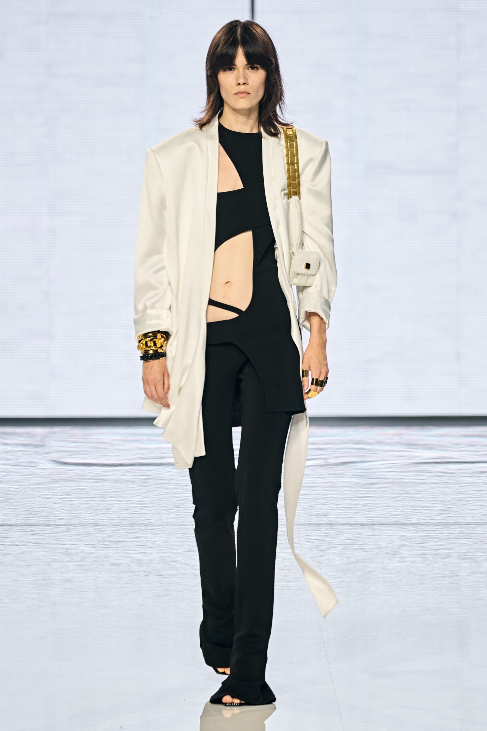 white relaxed jacket with black fitted top and pants