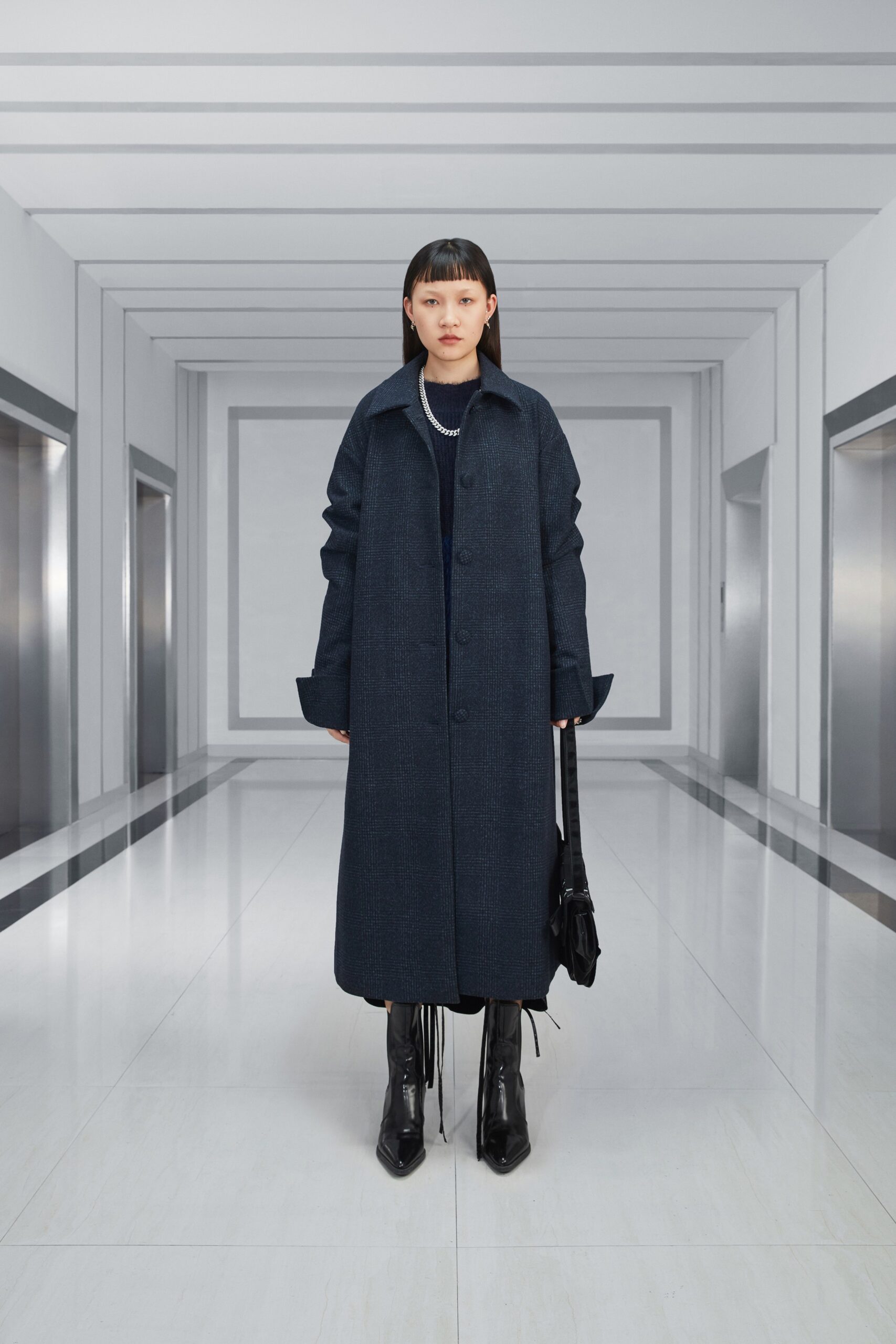 black oversized coat and fitted dress