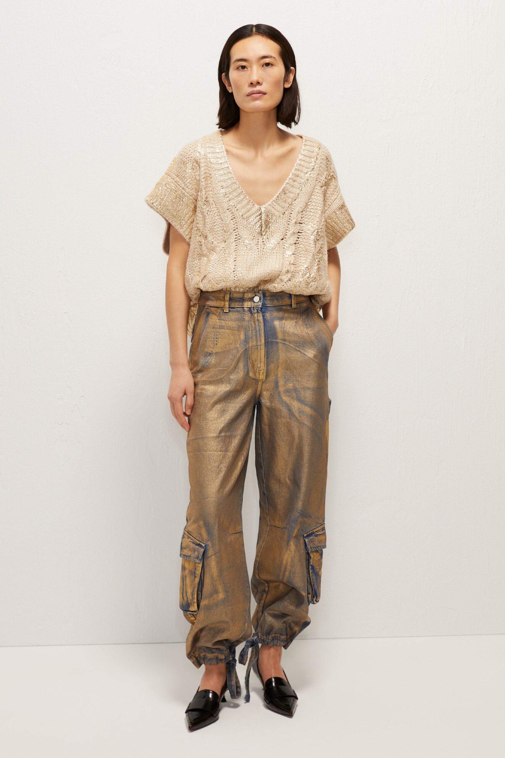 beige knit top with gold cargo pants