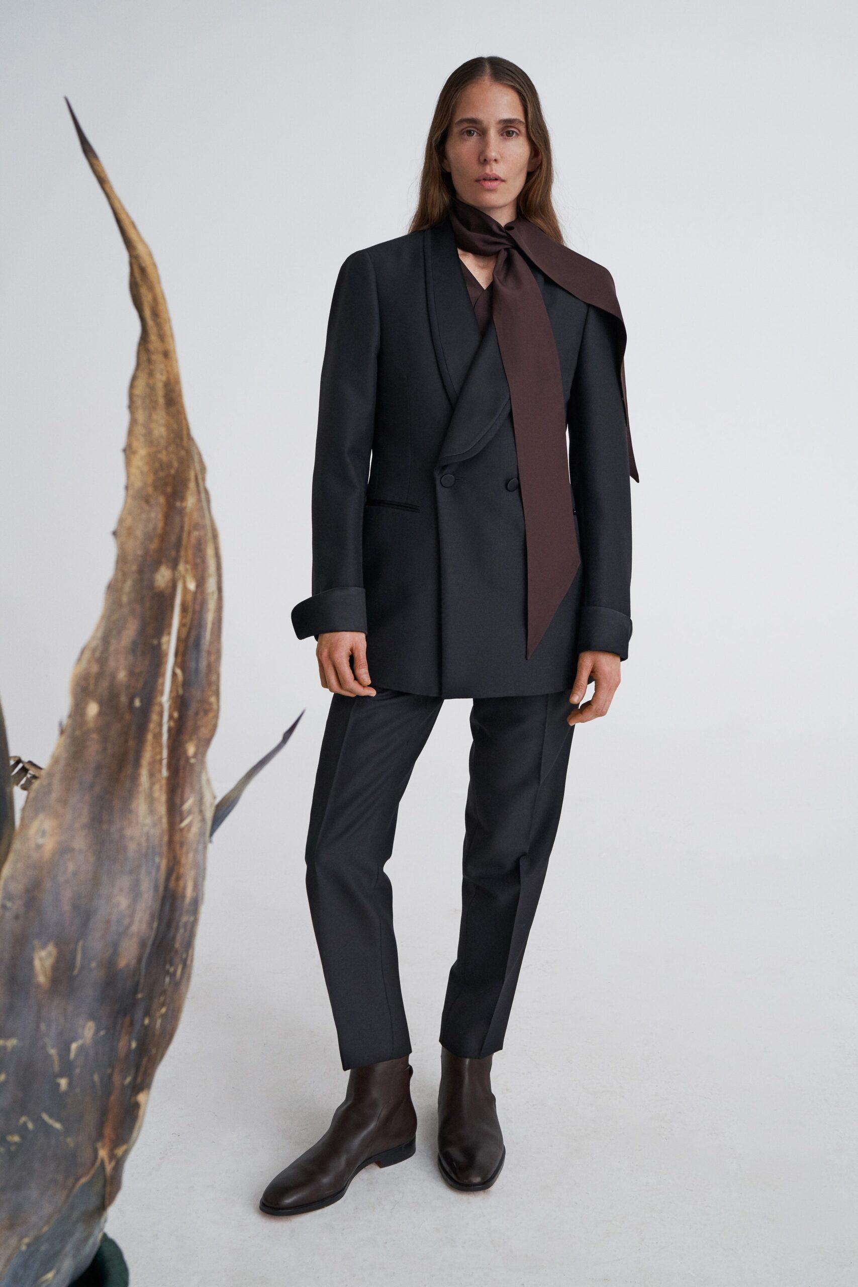 black tailored suit with brown scarf