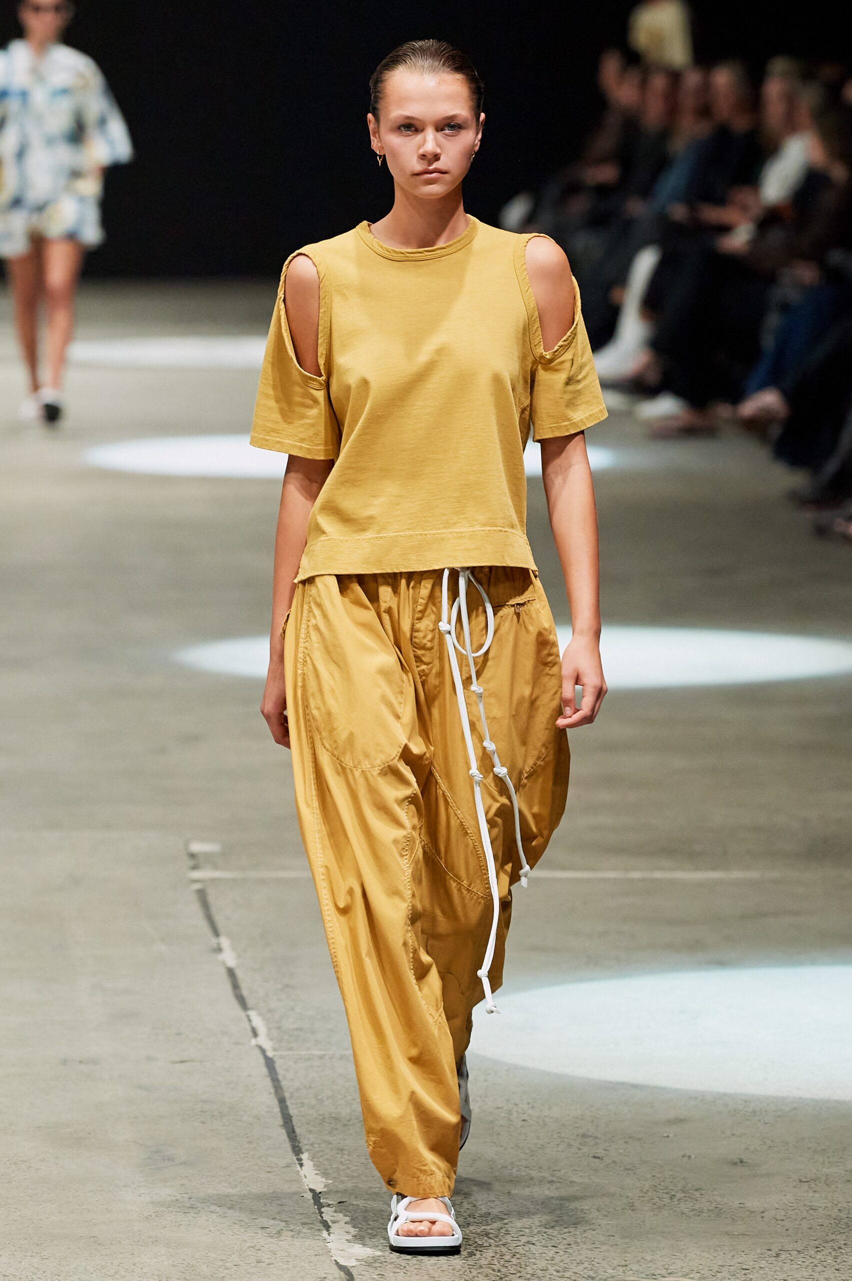 yellow cutout top and beige pants