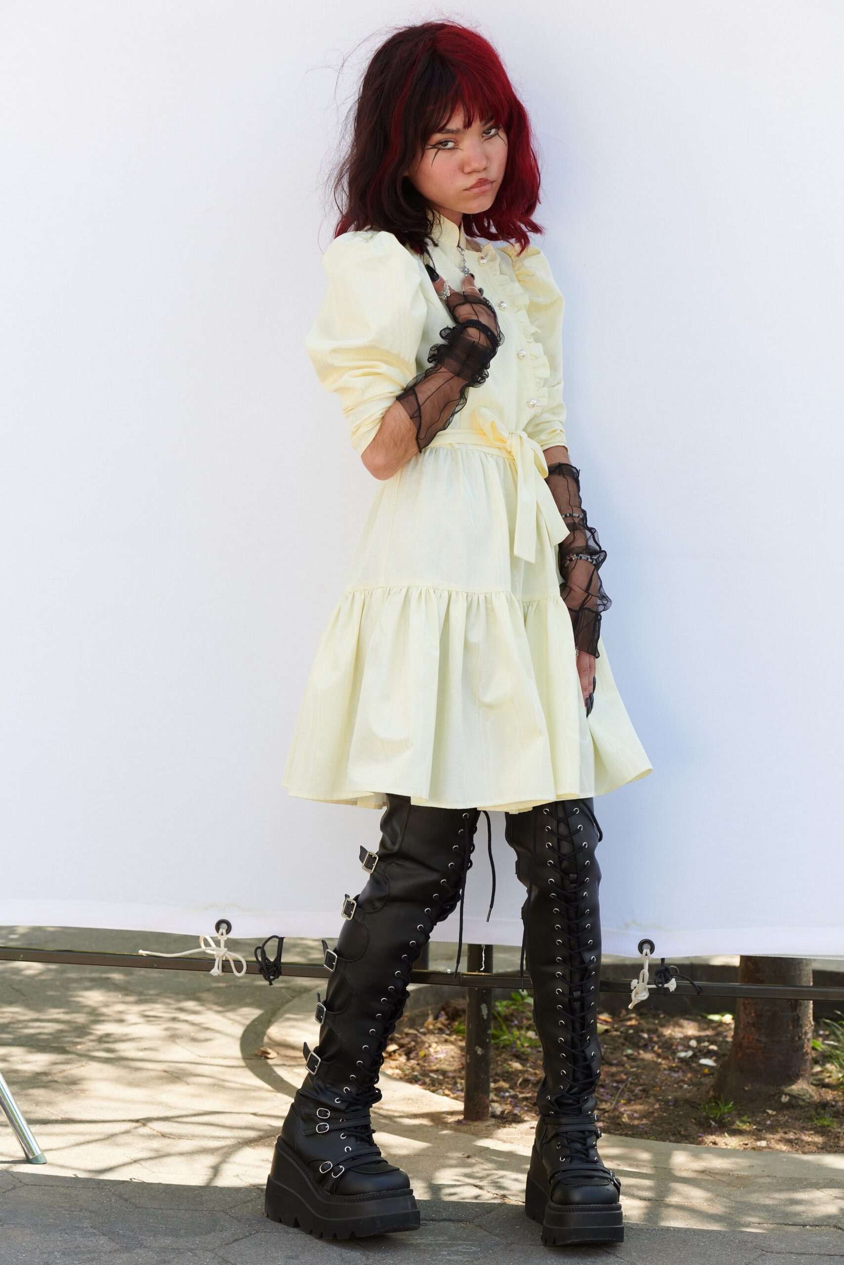 yellow mini dress with black boots