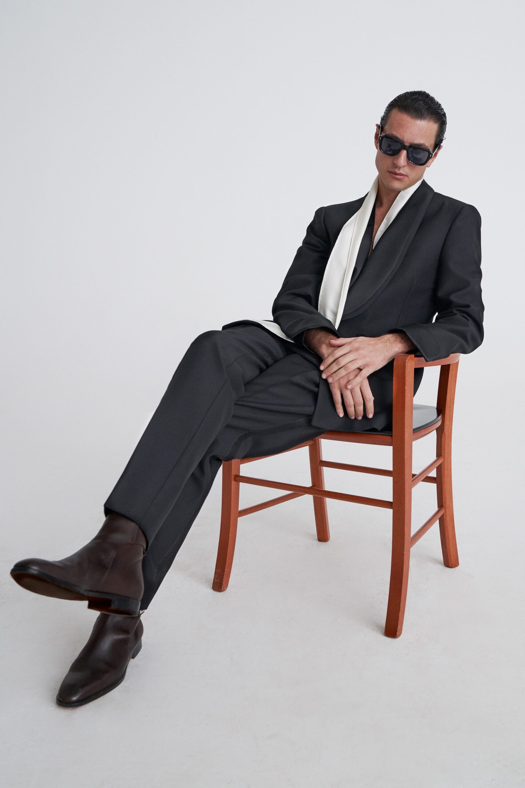 black tailored suit with white scarf