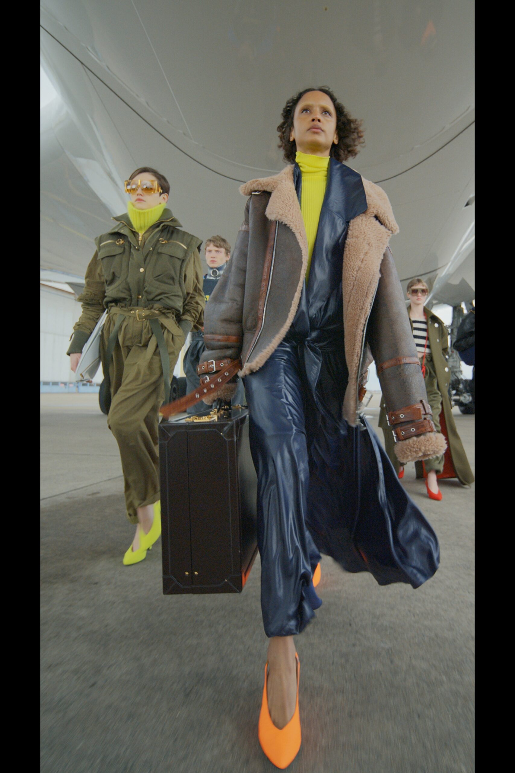 gray wool fitted jacket and blue vinyl jumpsuit