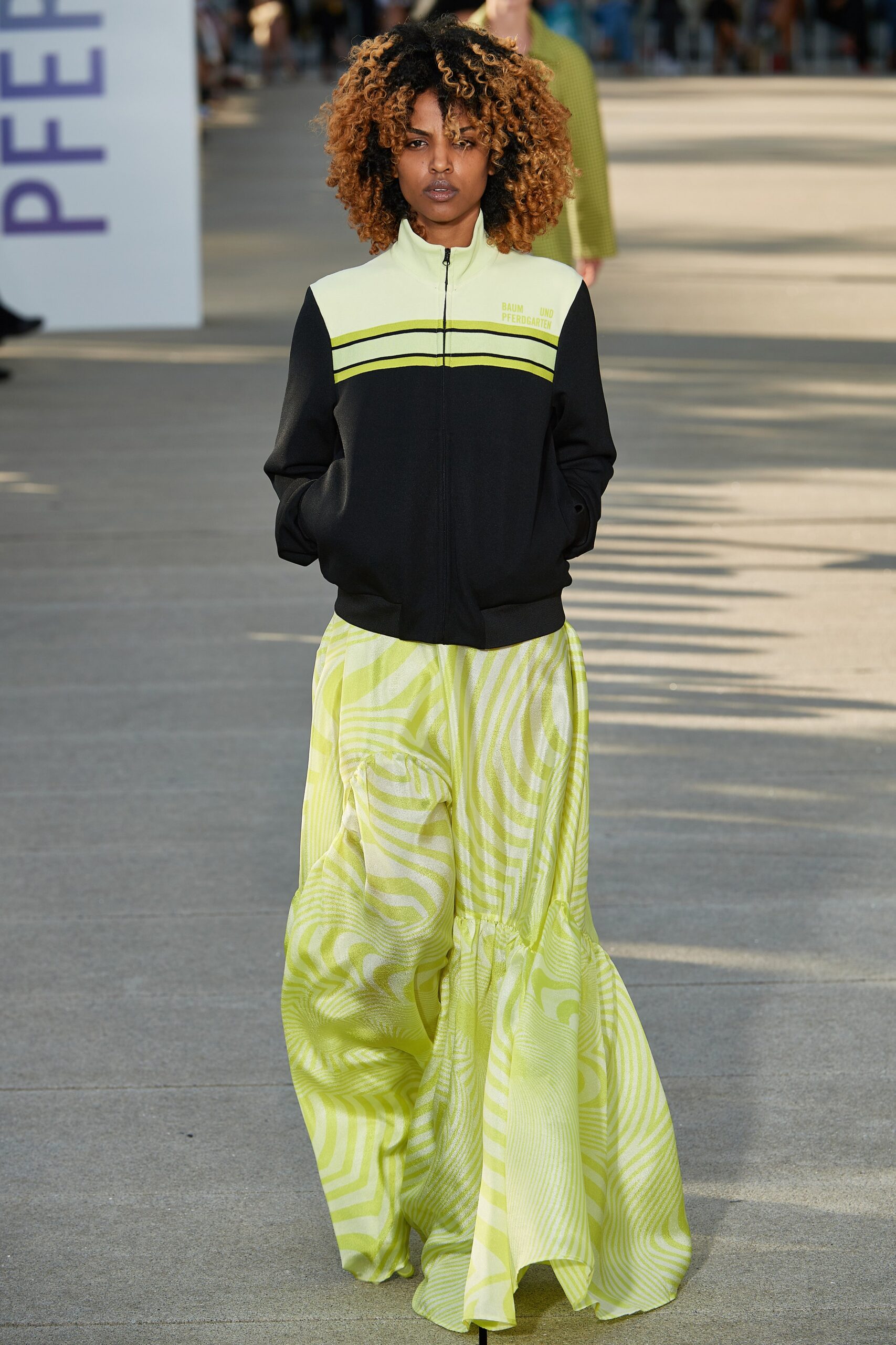 black and yellow fitted jacket with flared skirt