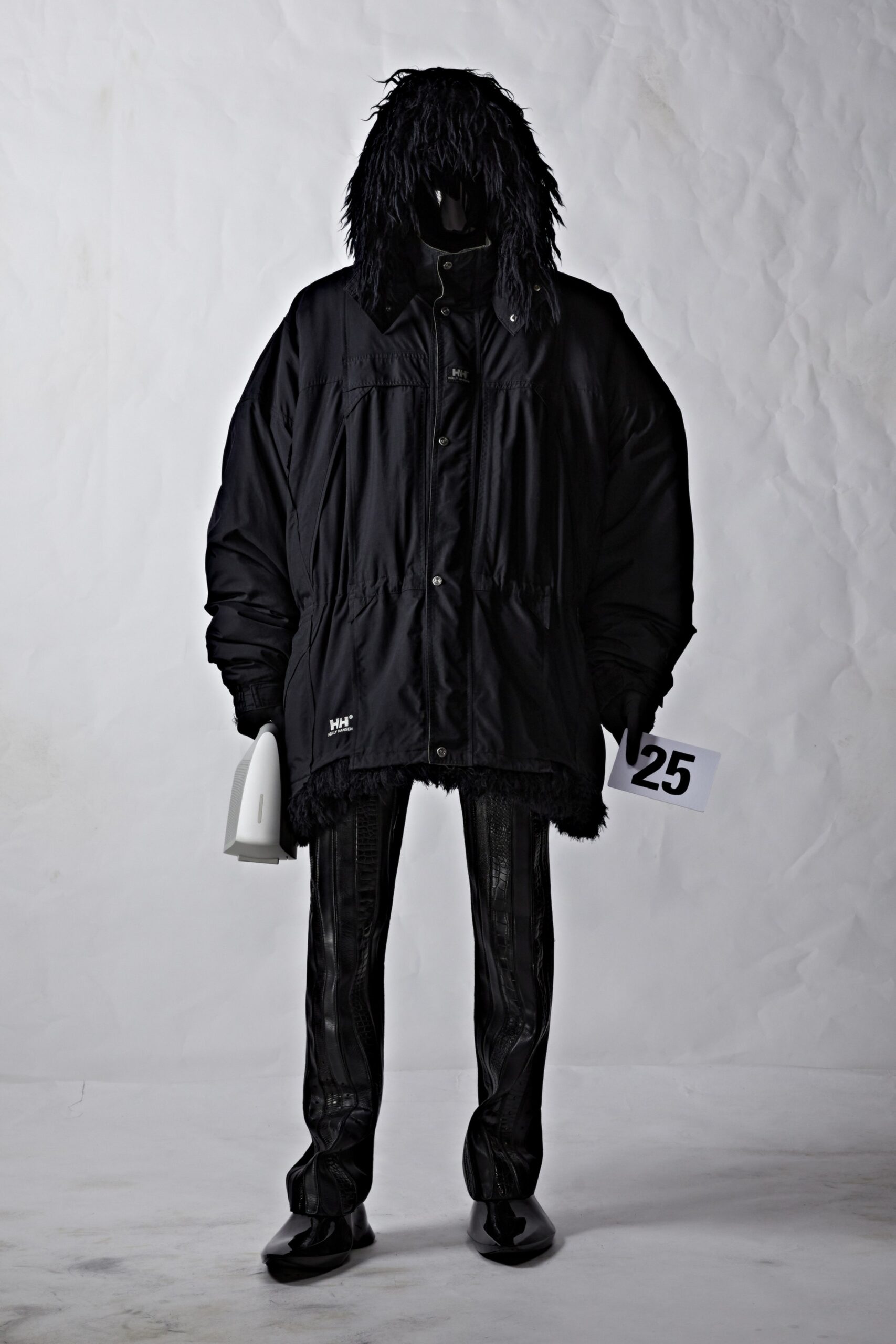 oversized black faux-fur jacket and fitted vinyl pants