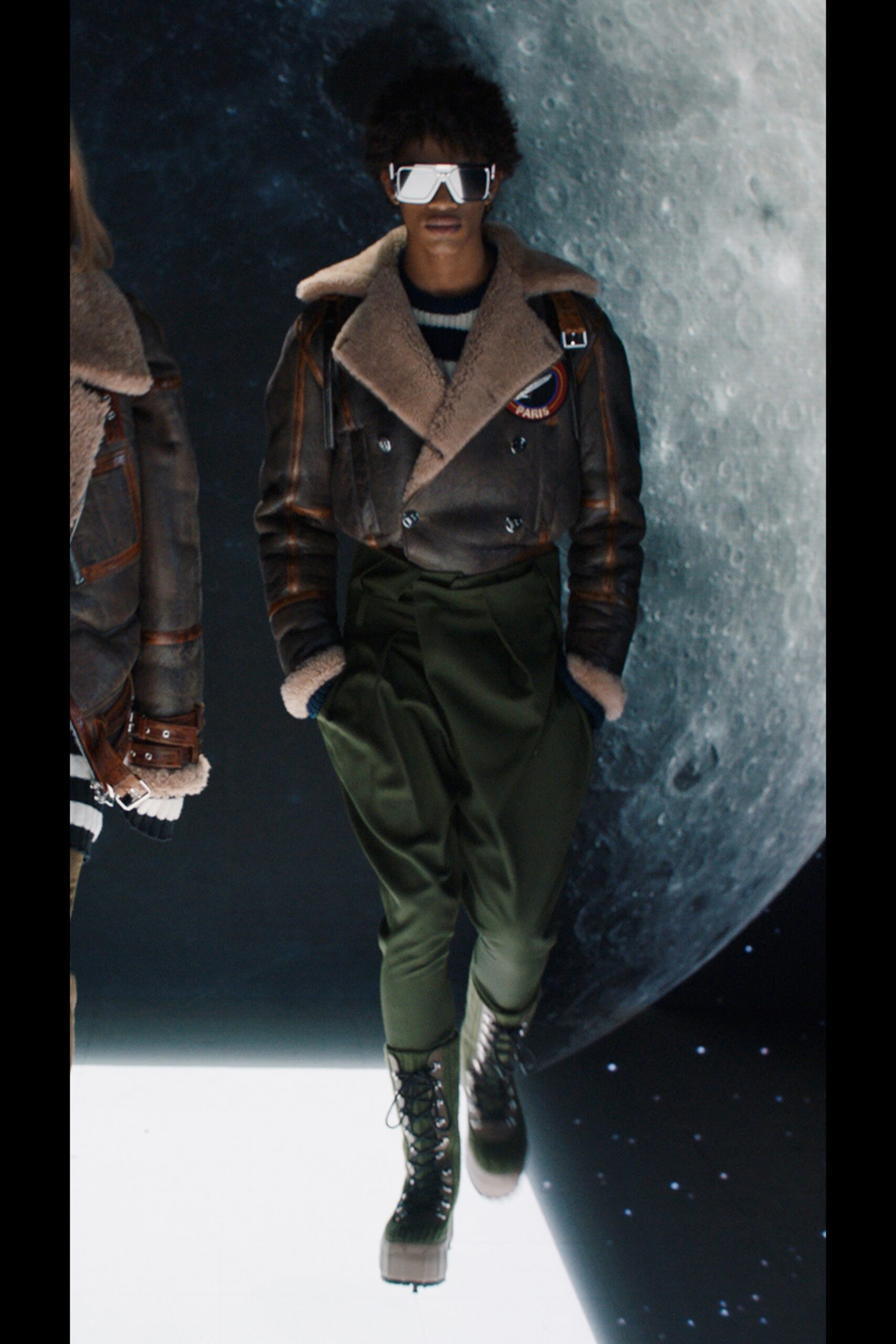 gray leather jacket with green pants