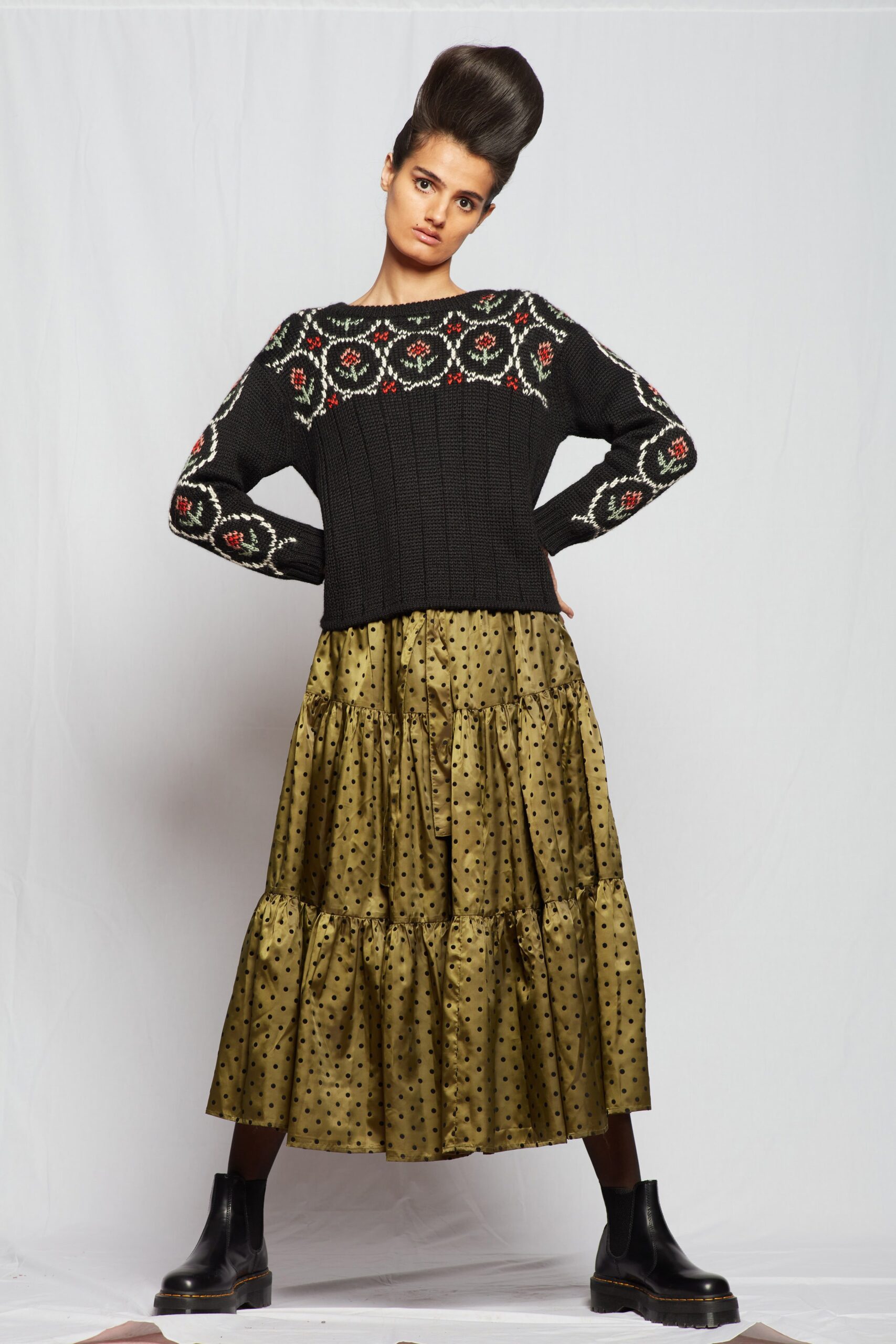 black embroidered sweater and green polka-dot skirt