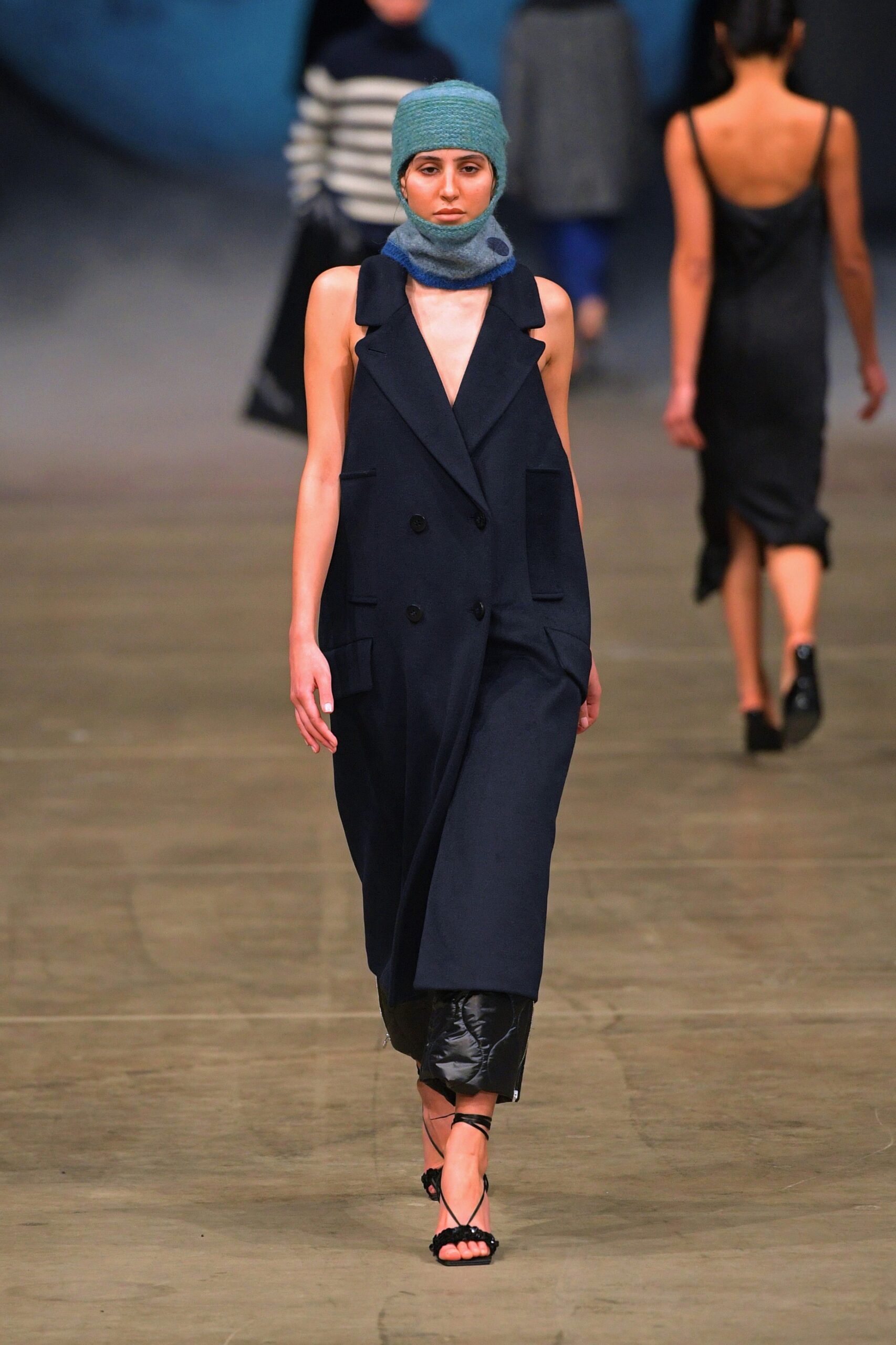 black fitted midi dress with blue coat