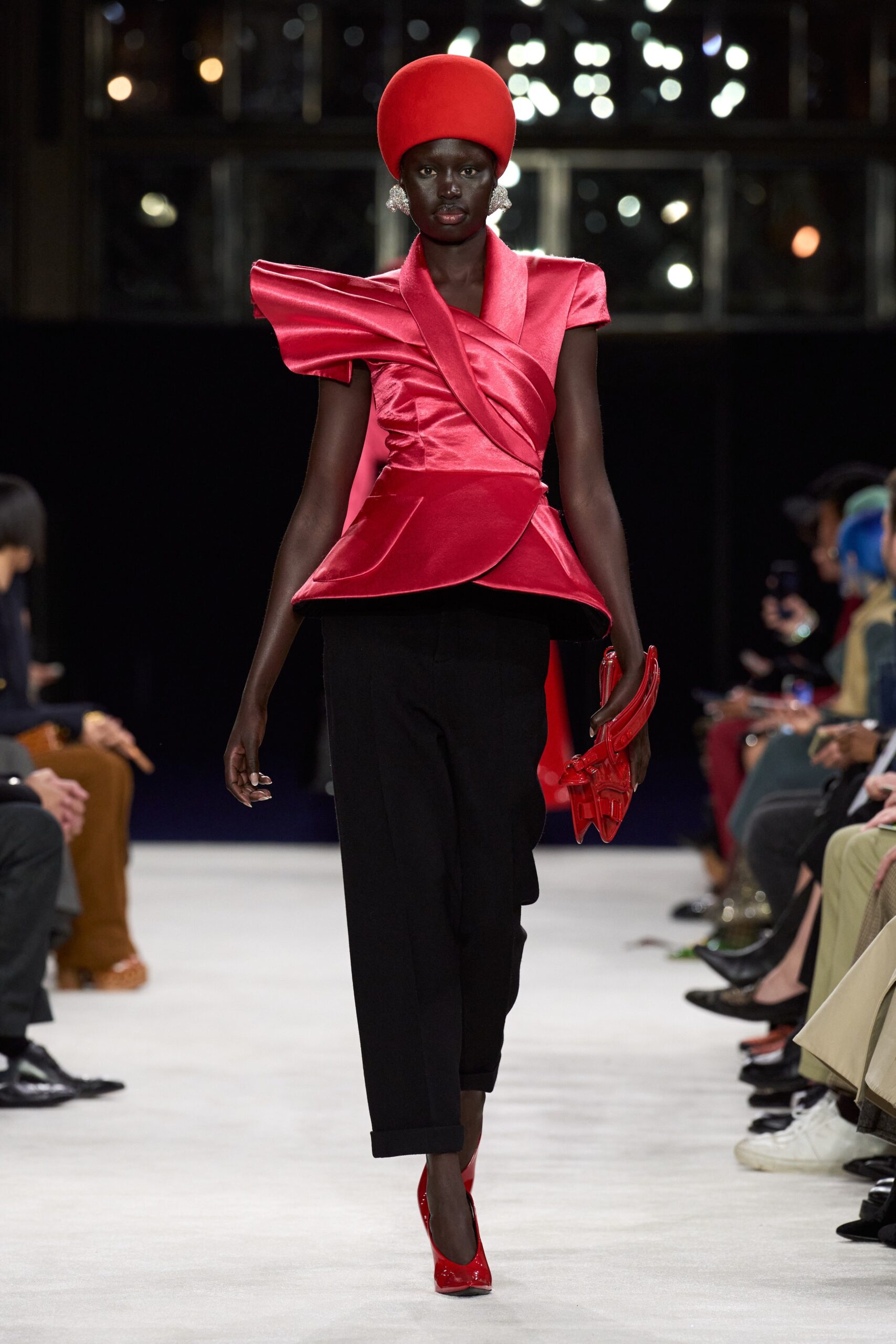 red silk top with black pants