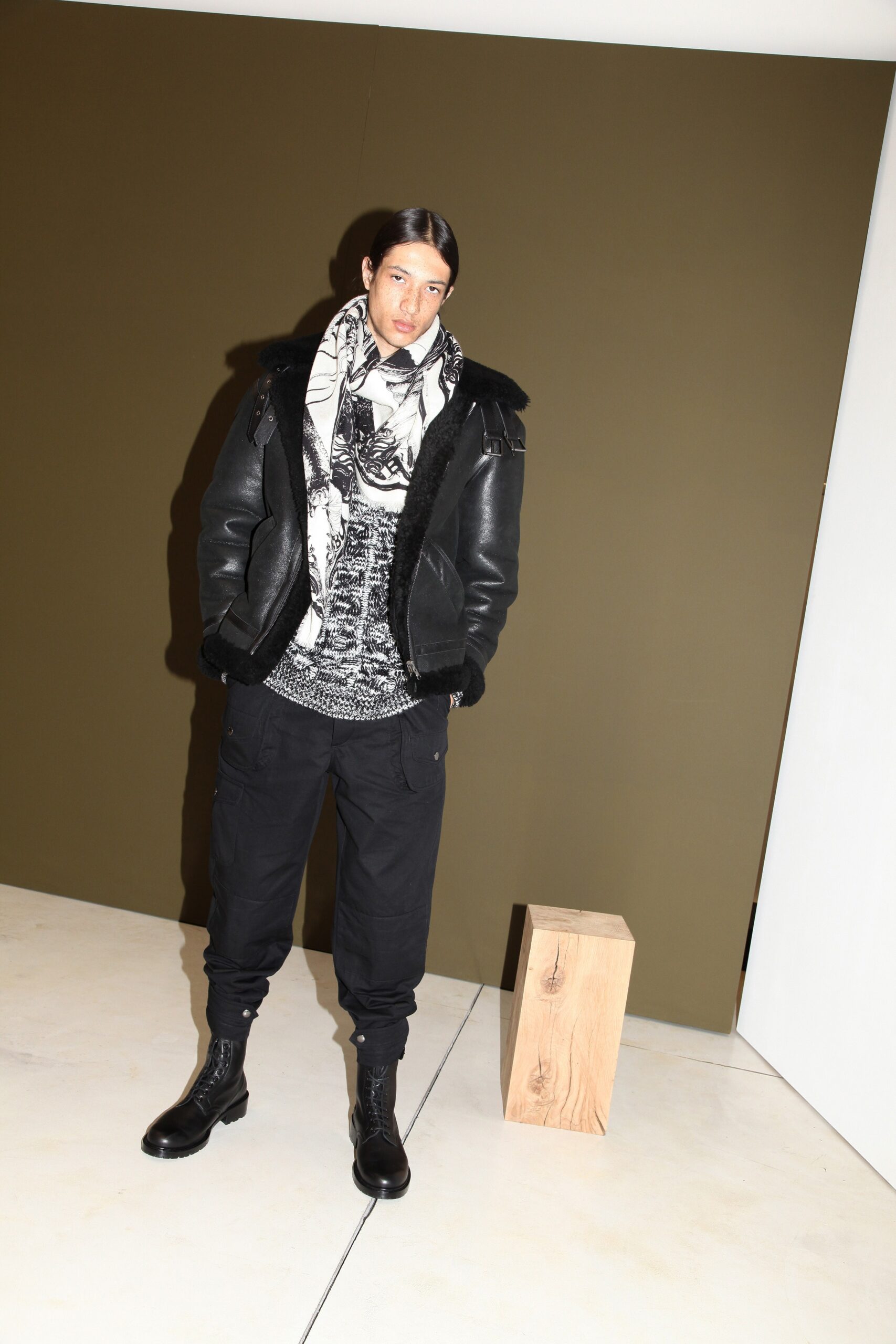 black leather jacket with gray sweater