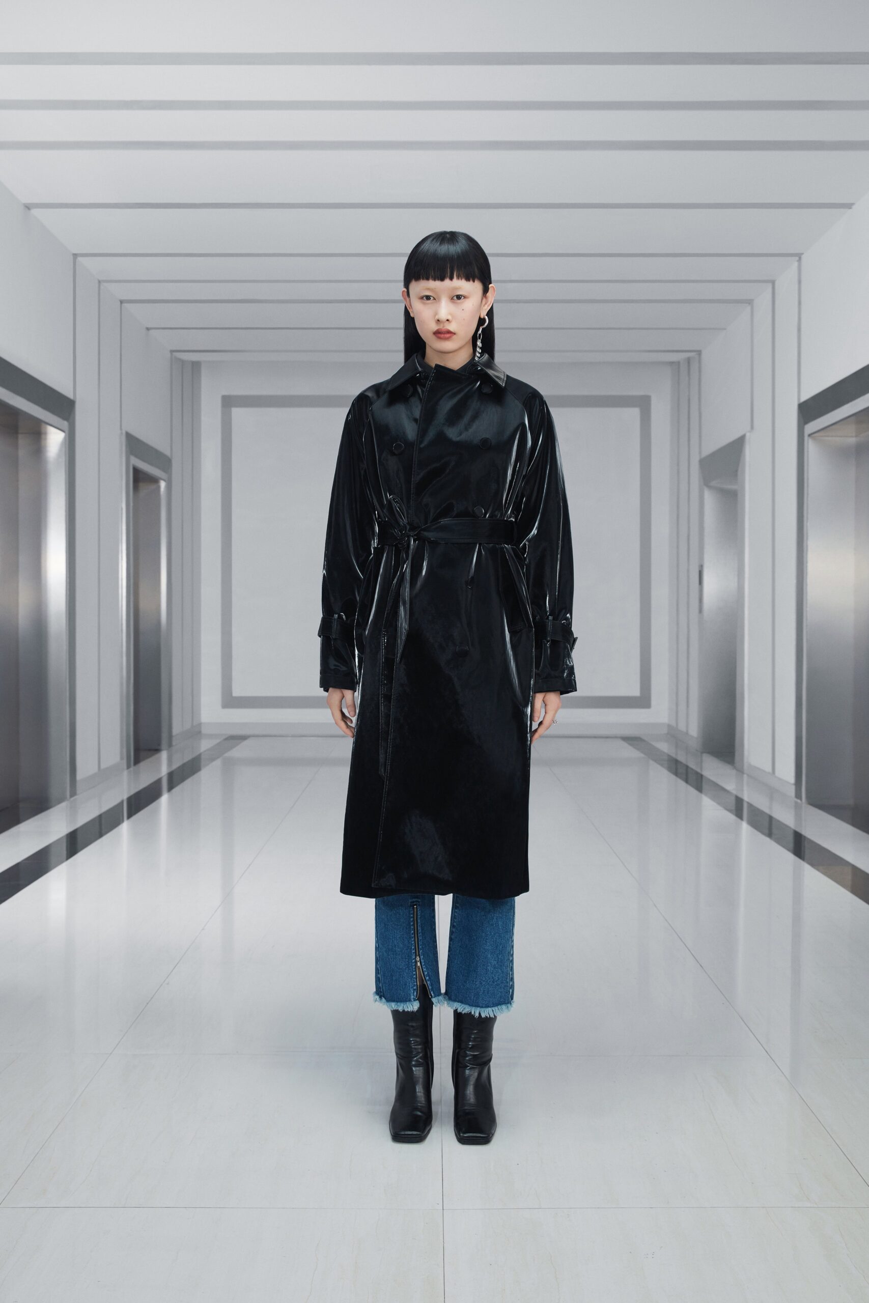 black vinyl belted coat with denim pants