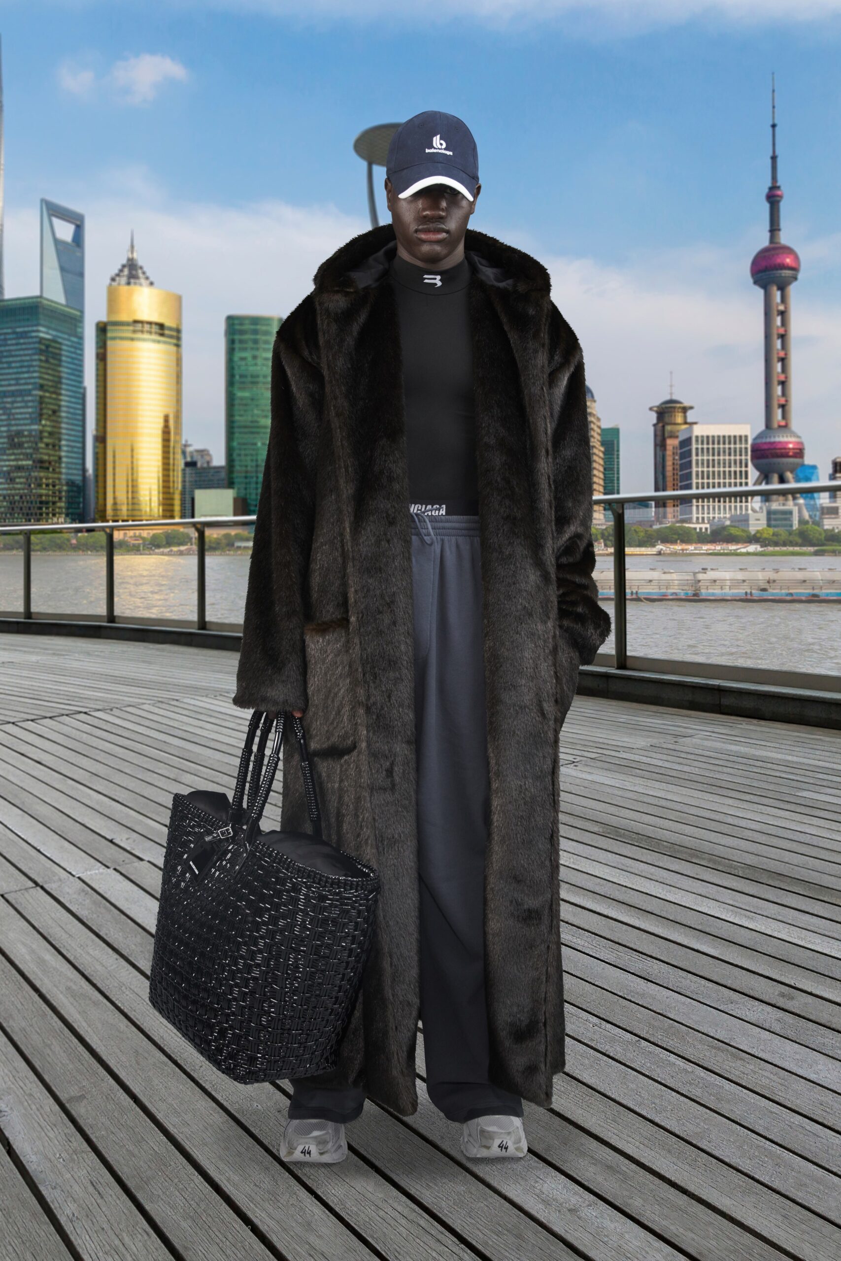 black faux-fur coat with gray pants